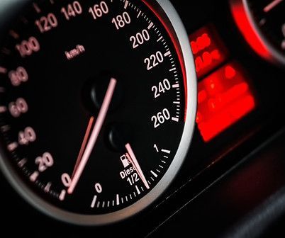 A close up of a car dashboard with a speedometer showing 260