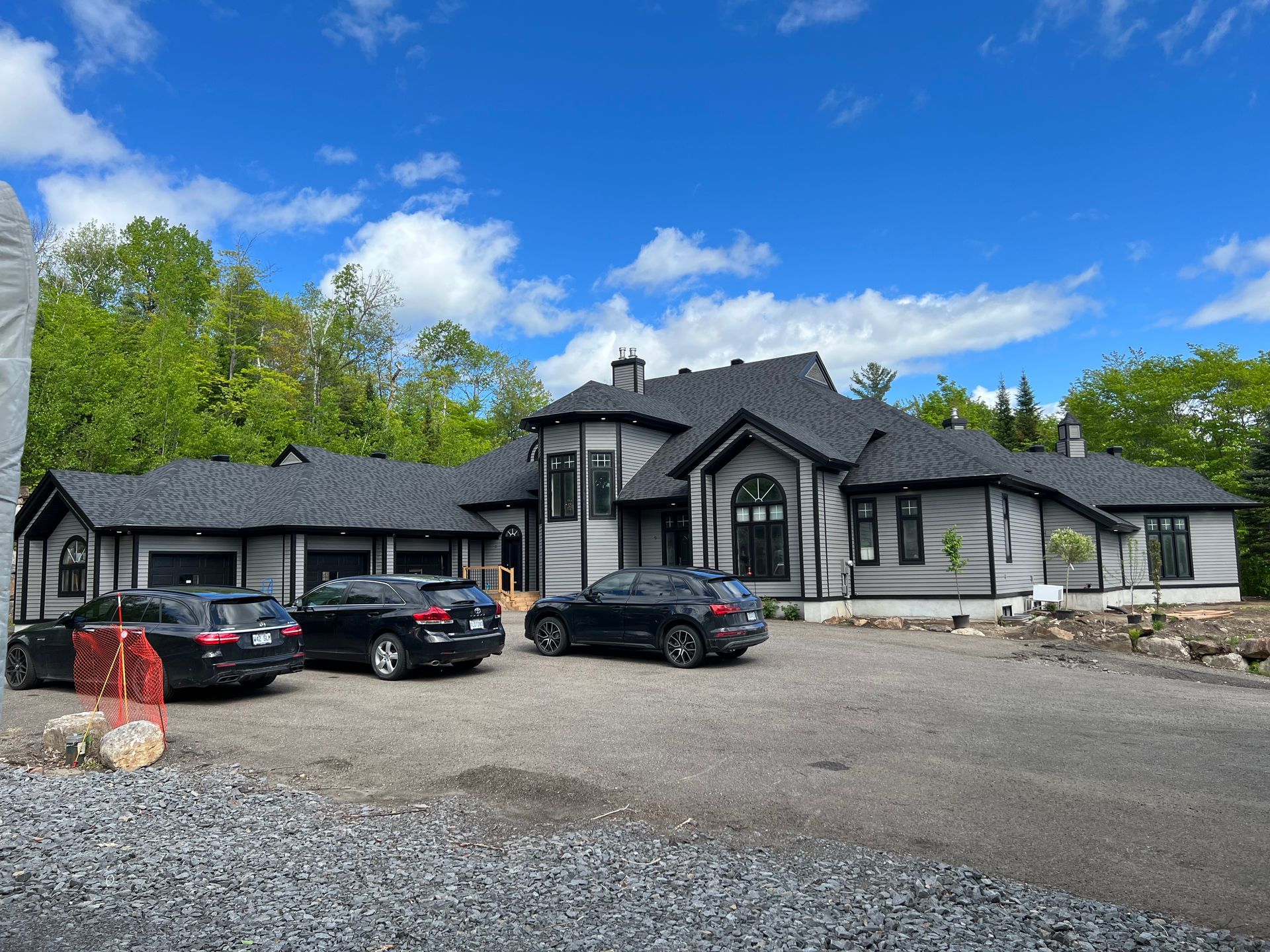 une grande maison avec beaucoup de voitures garées devant.