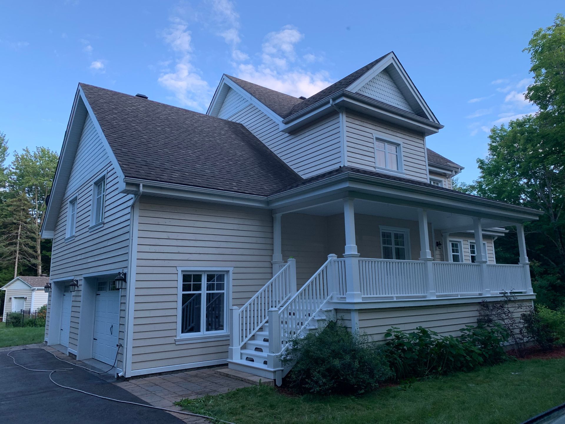 une grande maison avec un toit en bardeaux d'asphalte