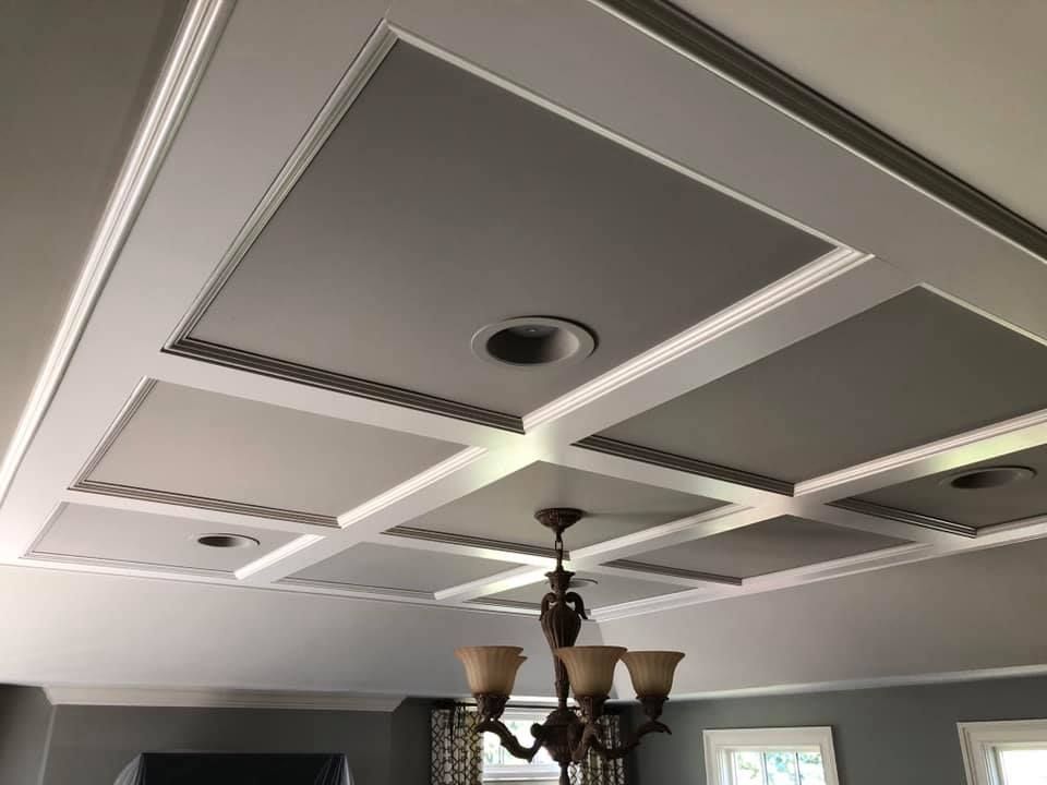 A chandelier is hanging from the ceiling of a living room.