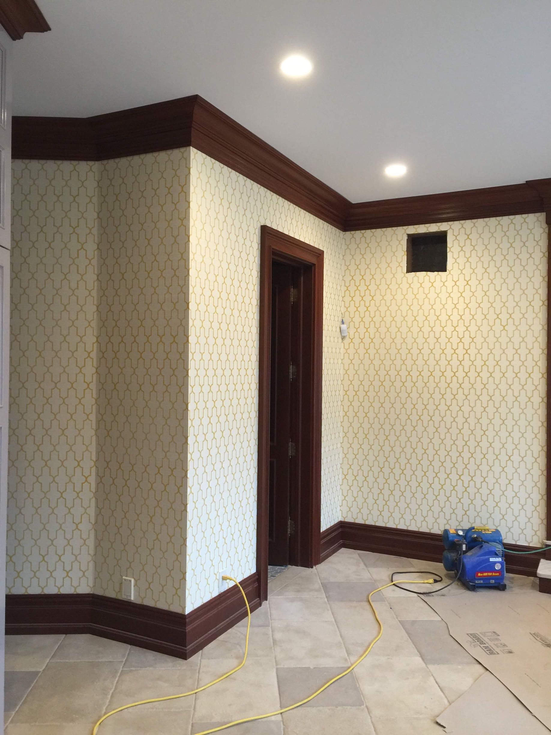 A room with a door and a yellow cord in it.