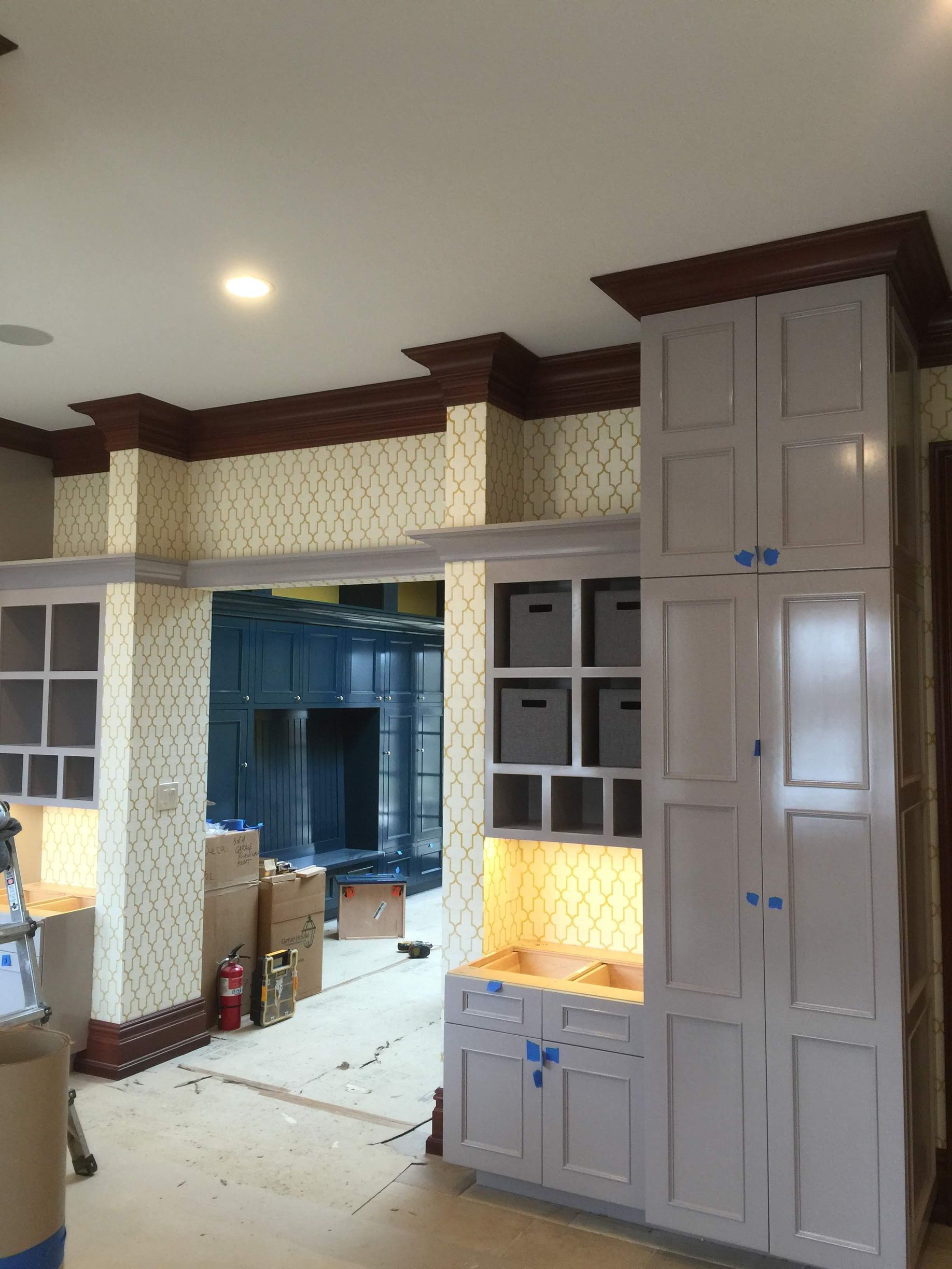 A room with a lot of cabinets and boxes on the floor