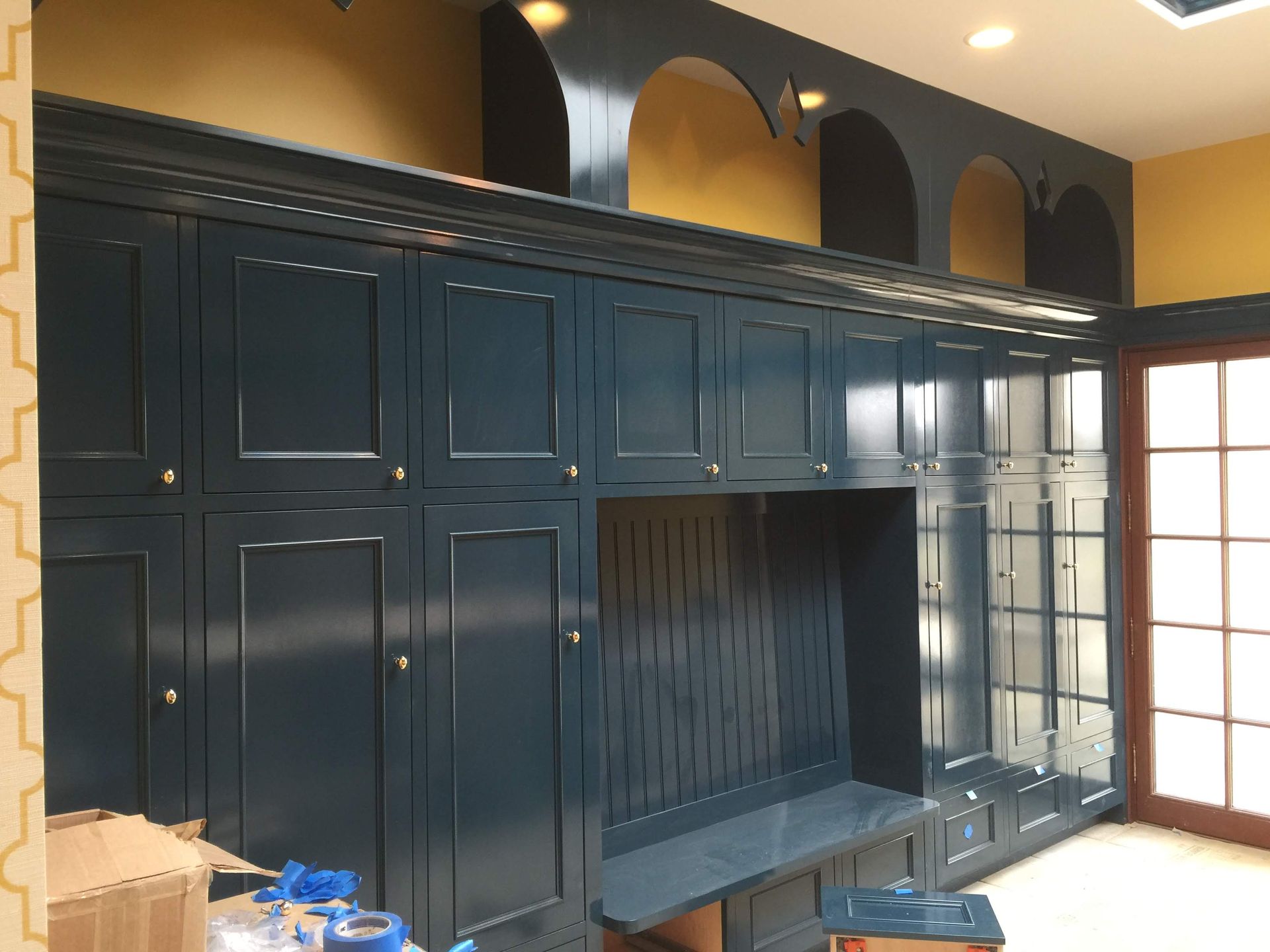 A room with a lot of cabinets and boxes on the floor