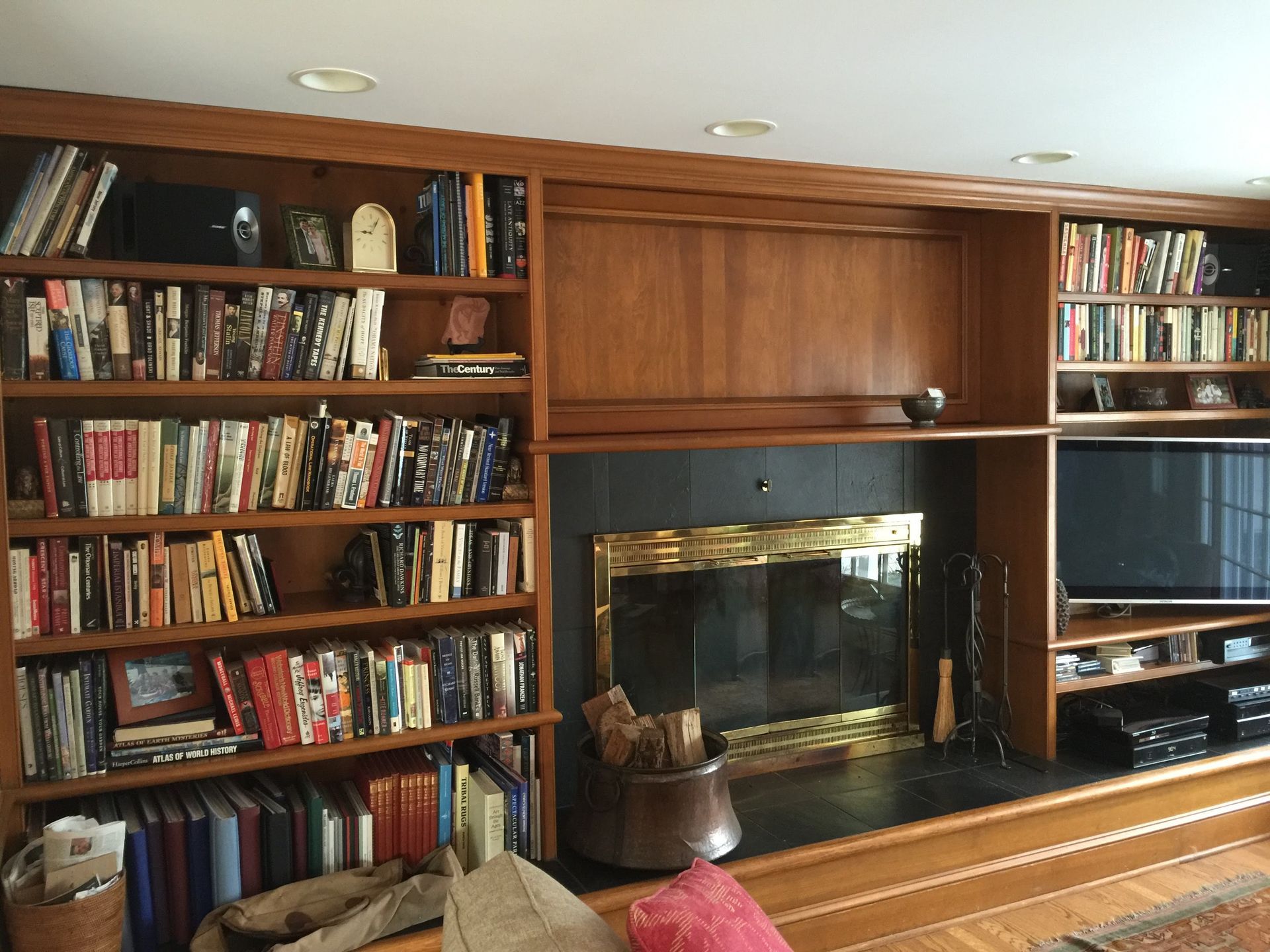 A living room filled with books and a fireplace