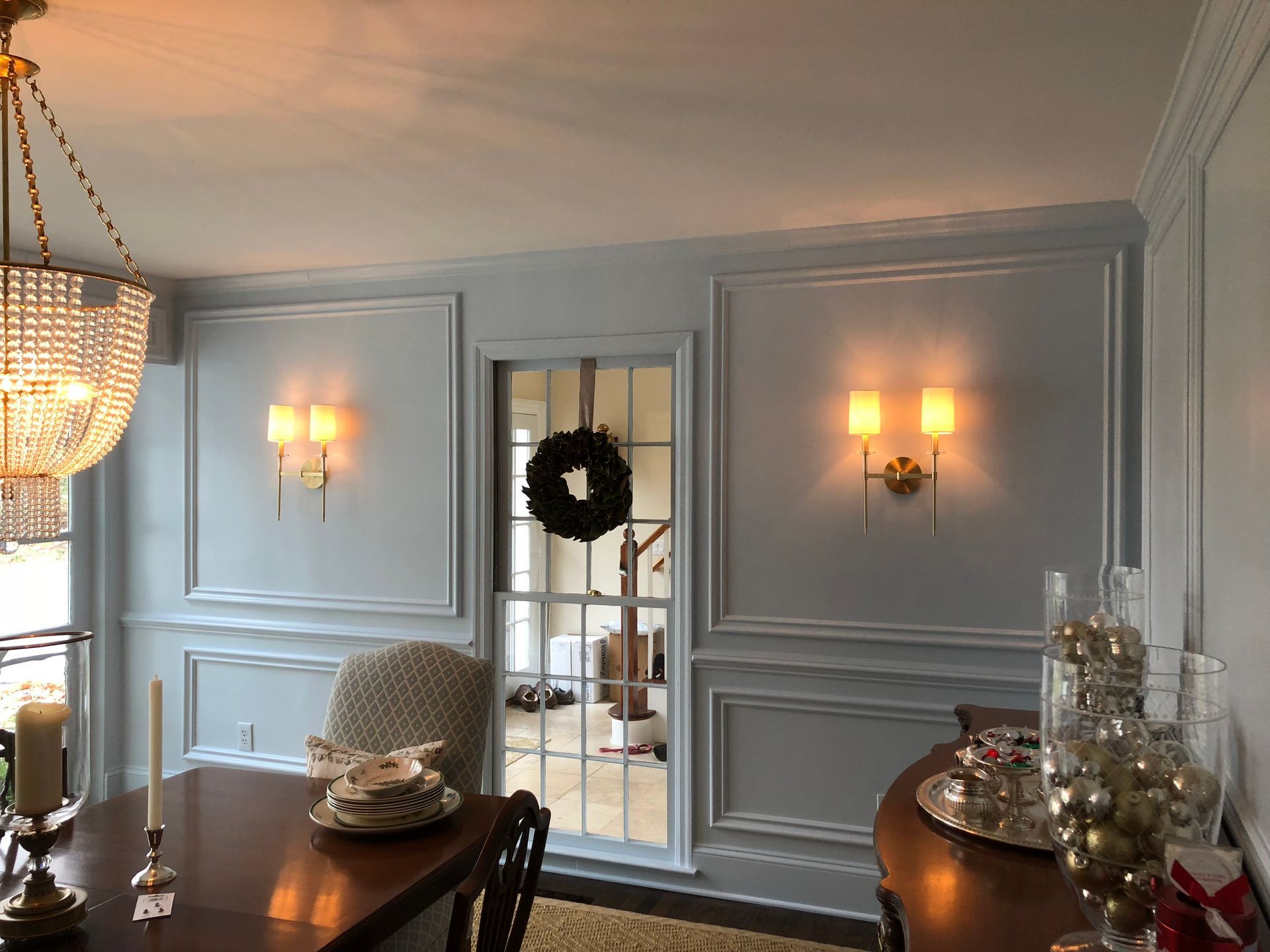 A dining room with a table and chairs and a chandelier.