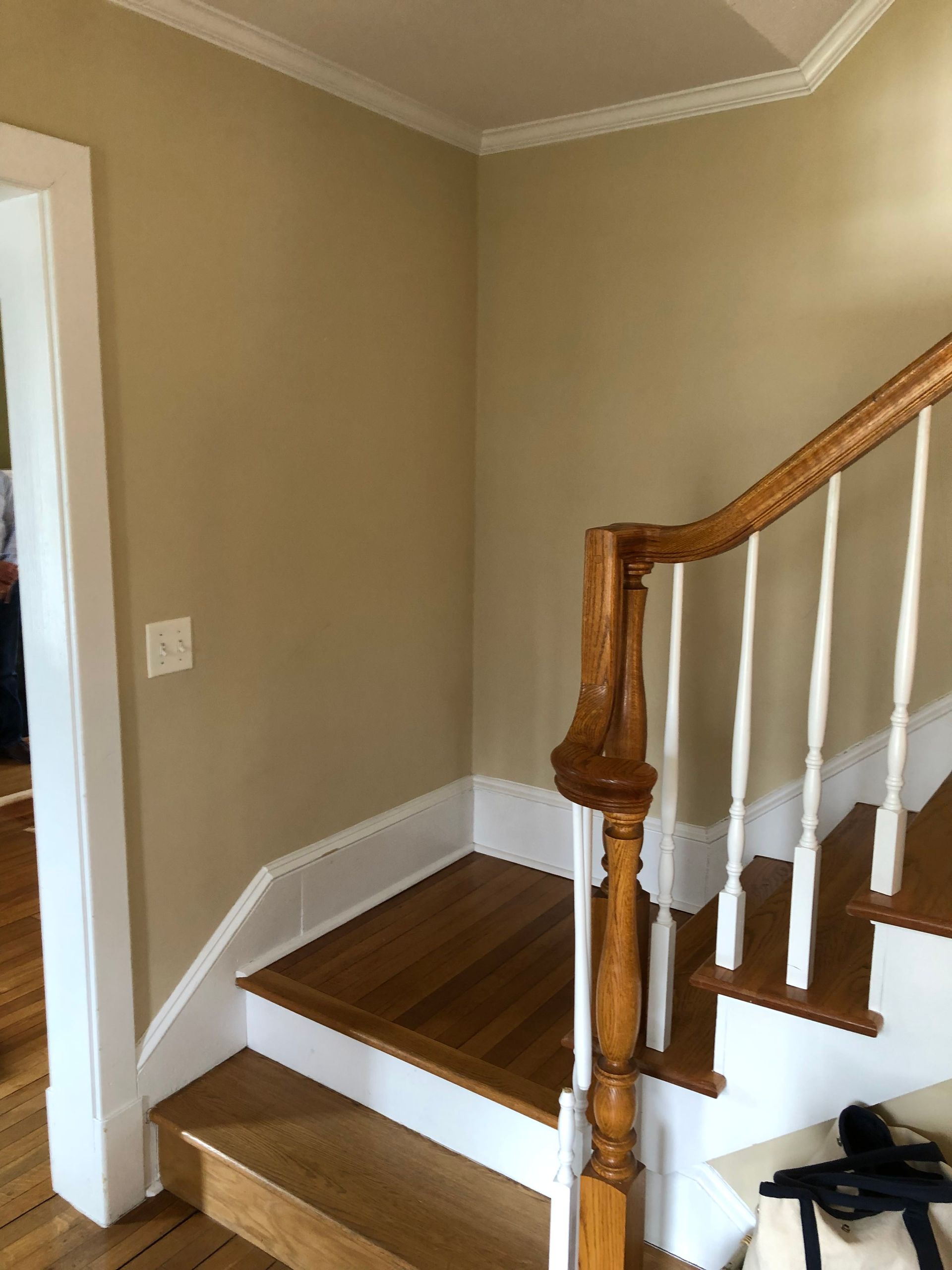 A staircase with wooden steps and white railings in a house.