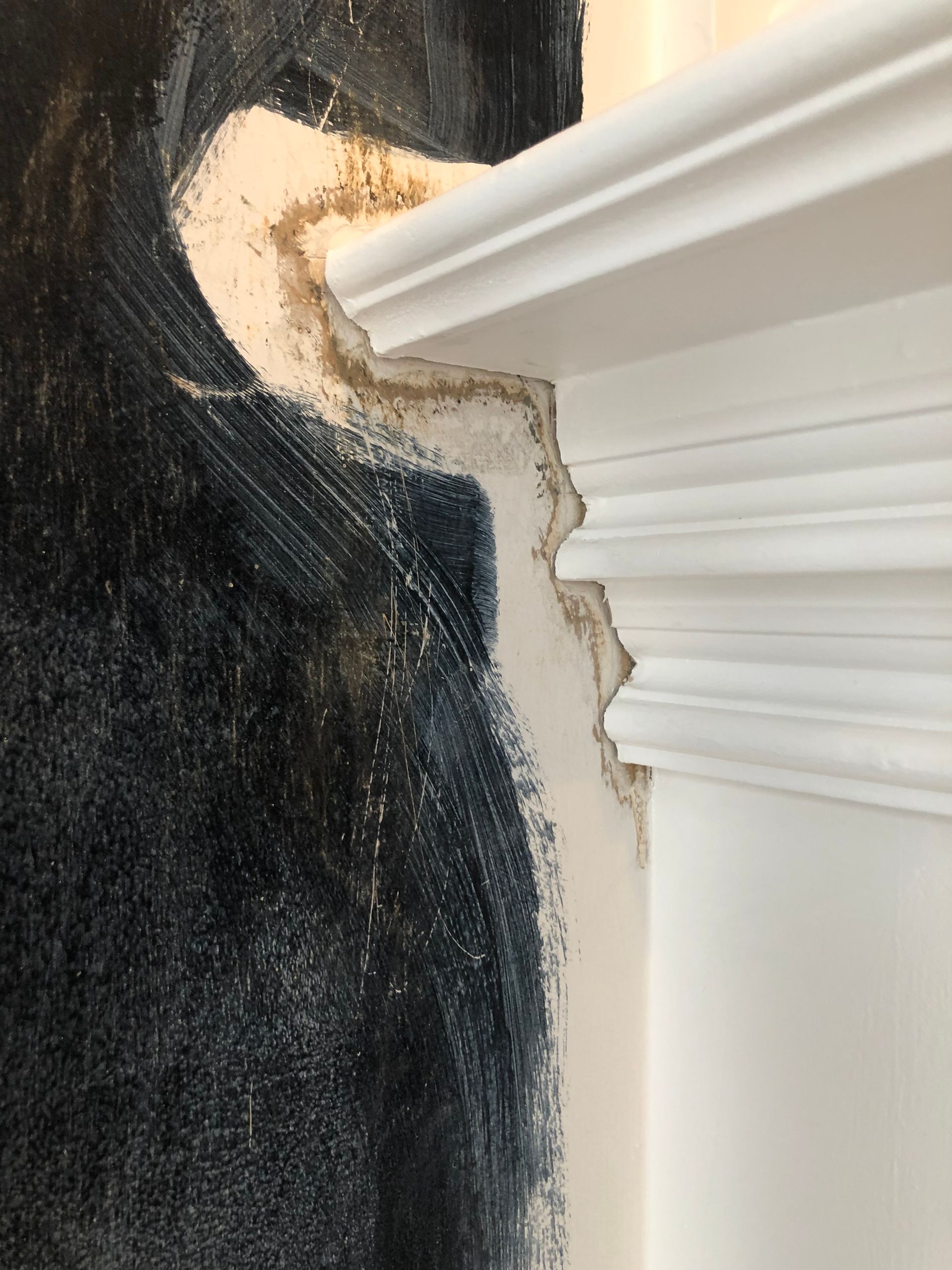 A close up of a wall with a painting on it.