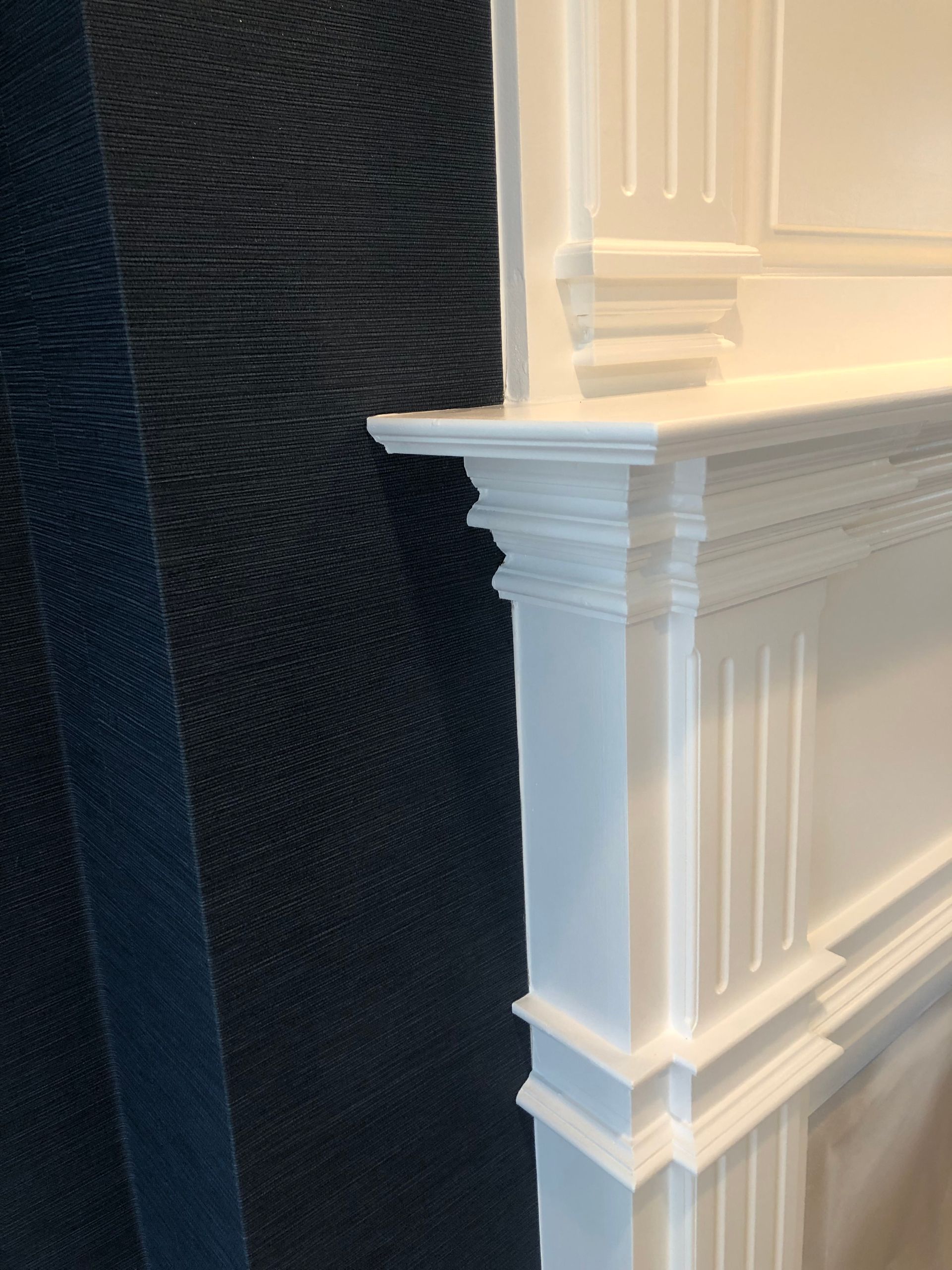 A white mantle with a black wall in the background