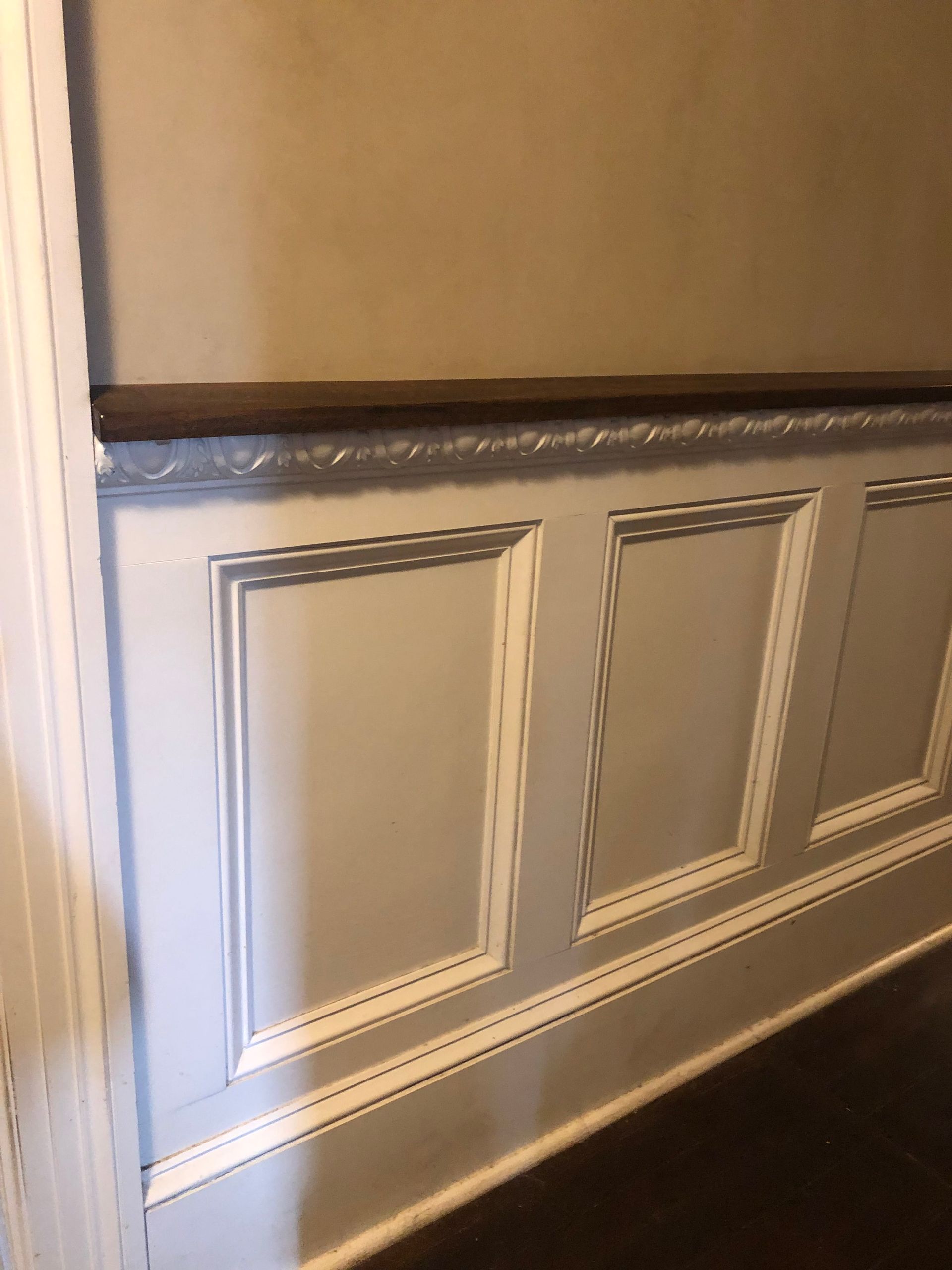 A close up of a wall with wood paneling on it.