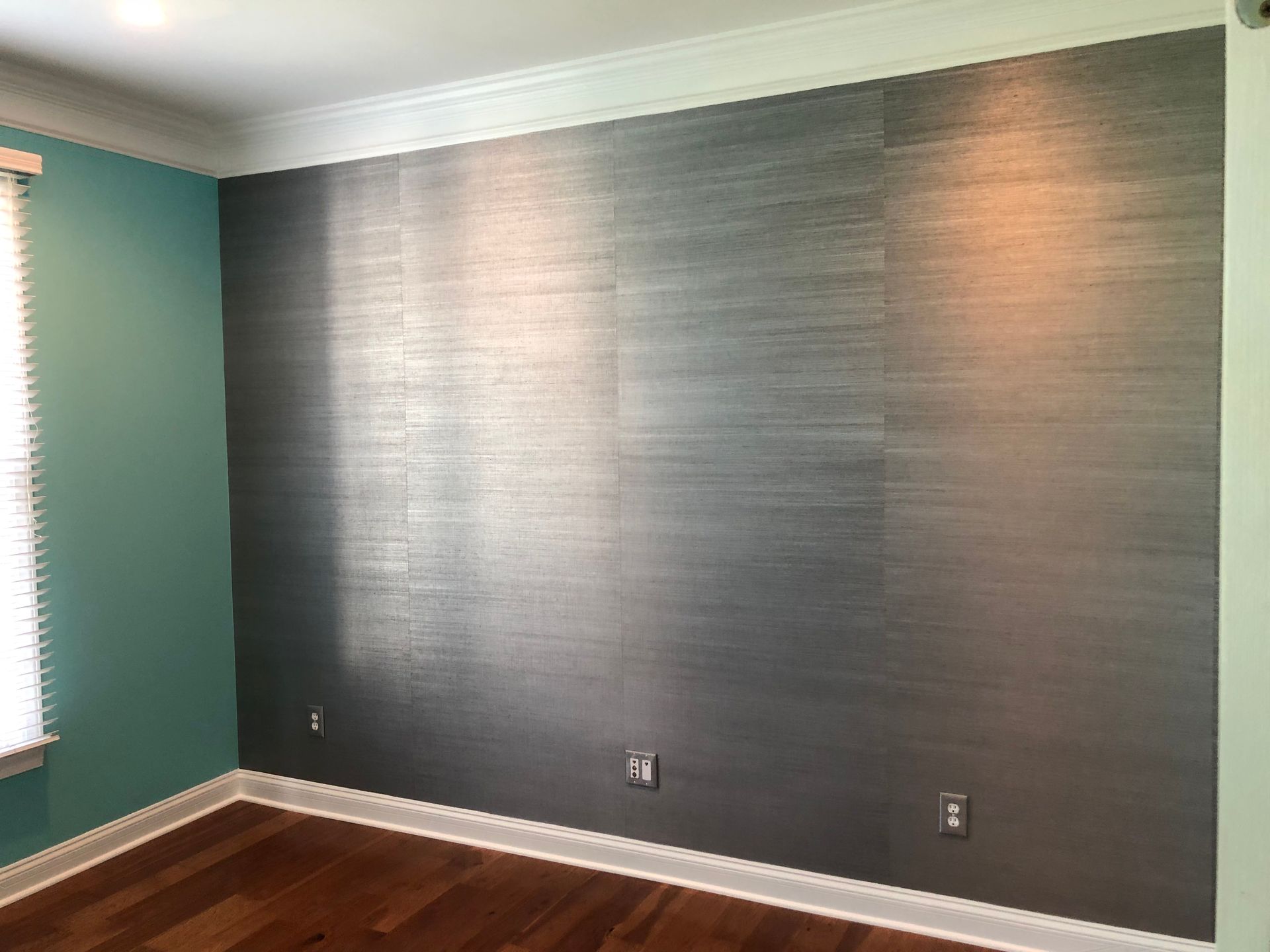 A room with a large wall and a window.