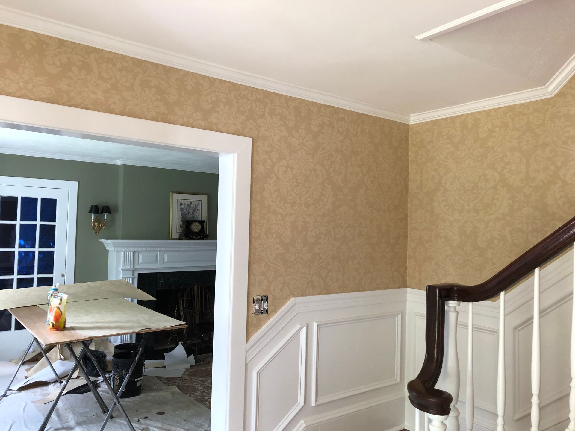 A room with a staircase and a fireplace in it