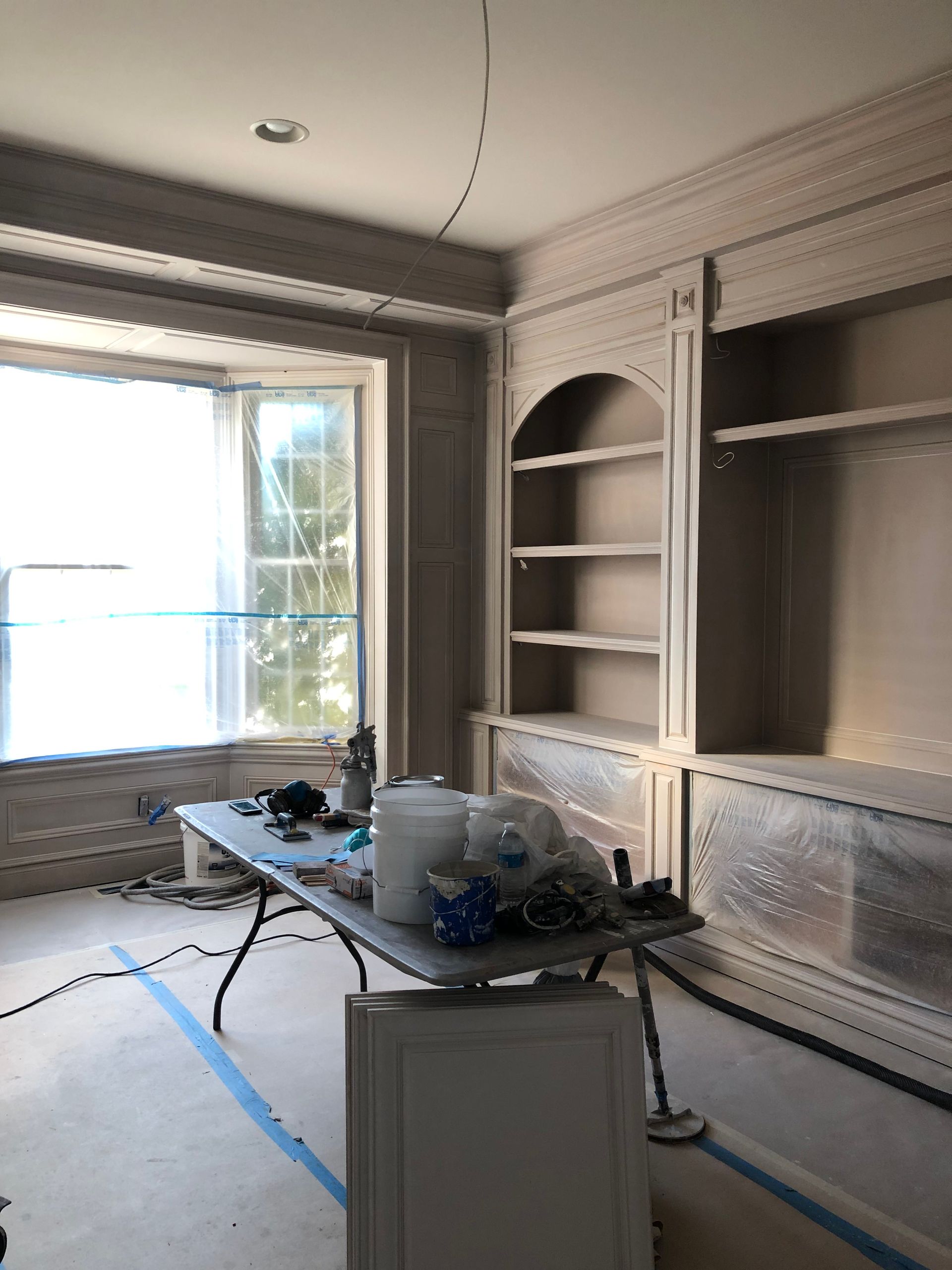 A room with a table and shelves in it