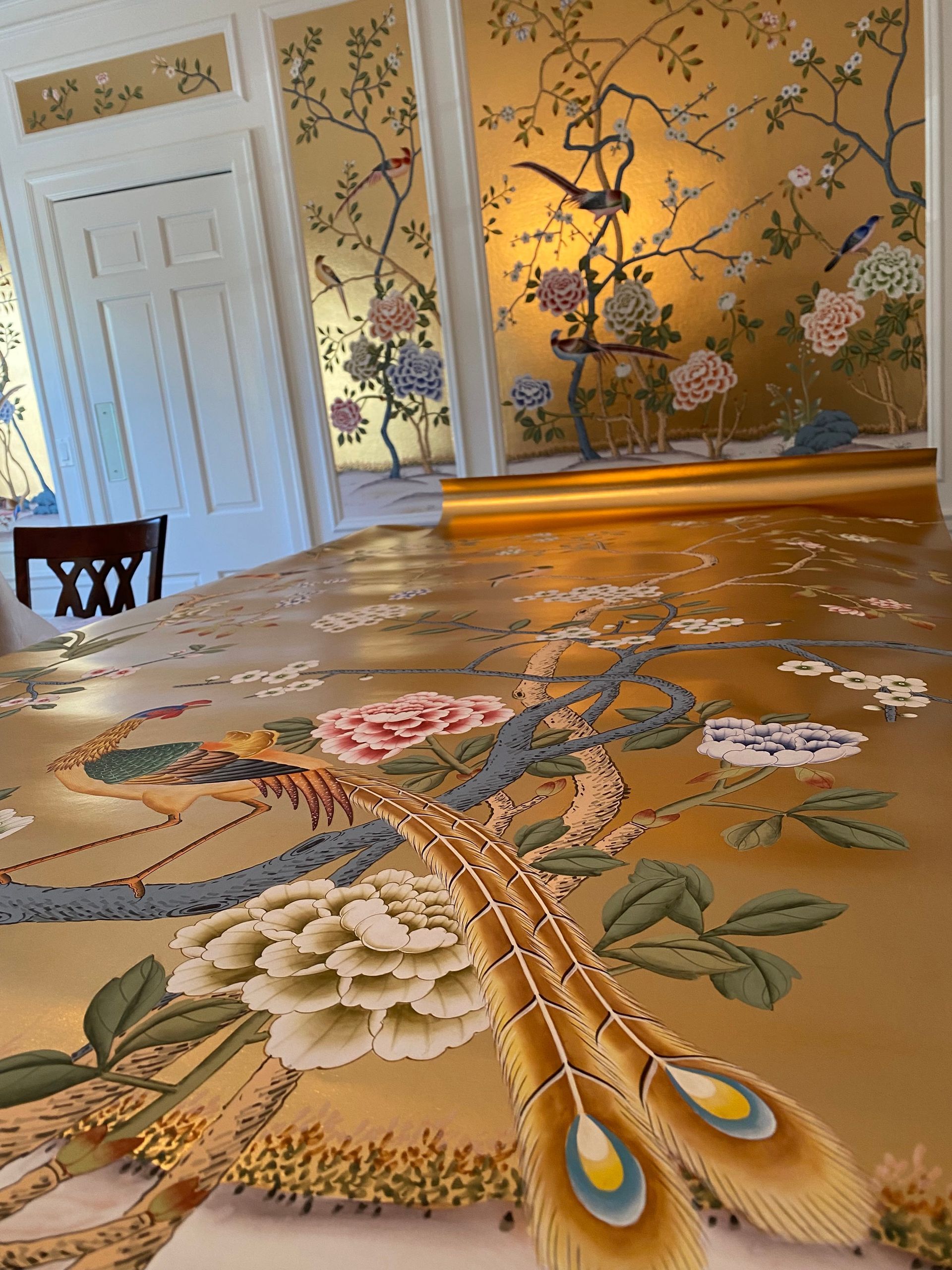 A rug with peacock feathers and flowers on it