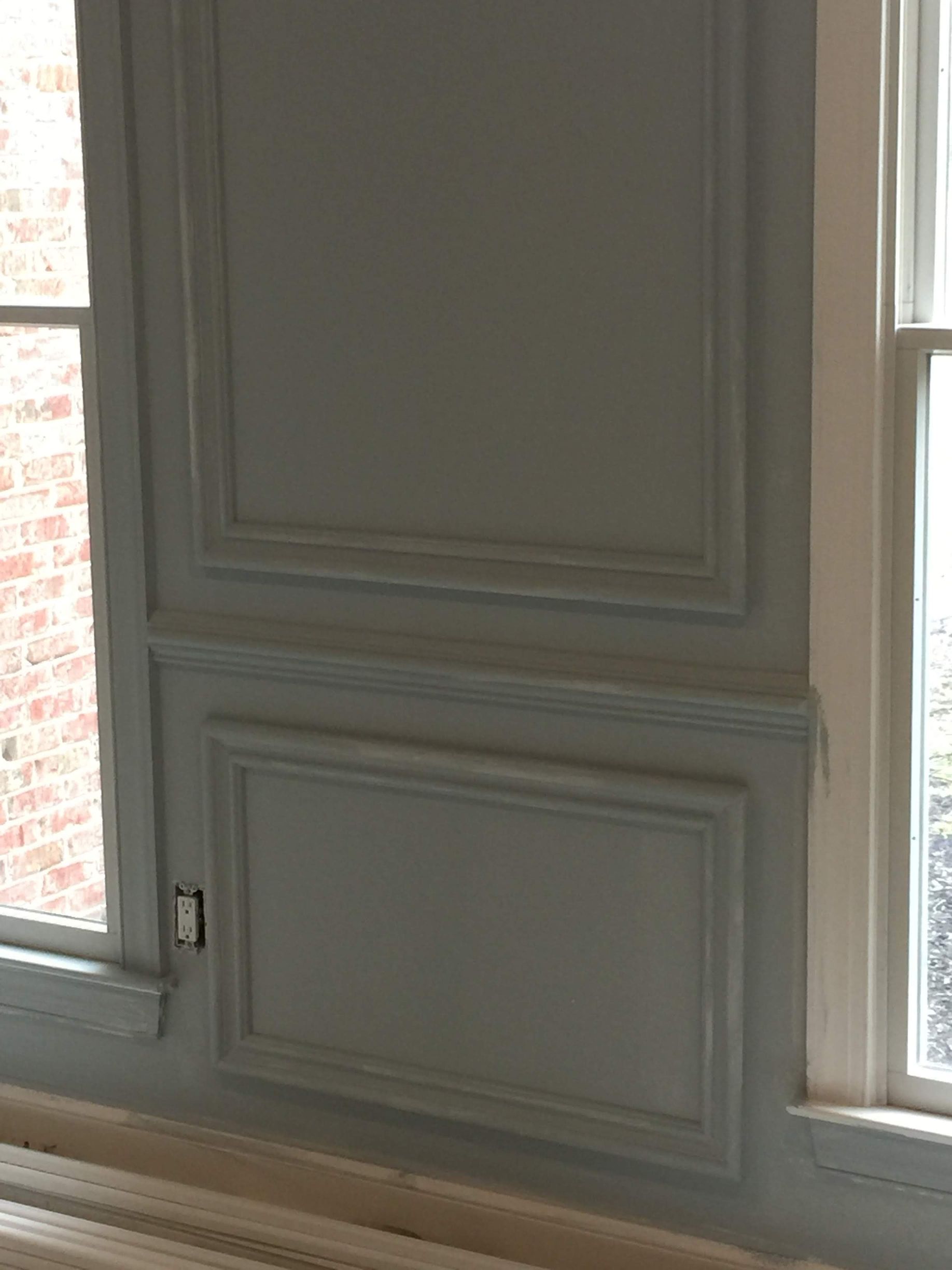 A close up of a window with a brick wall in the background.