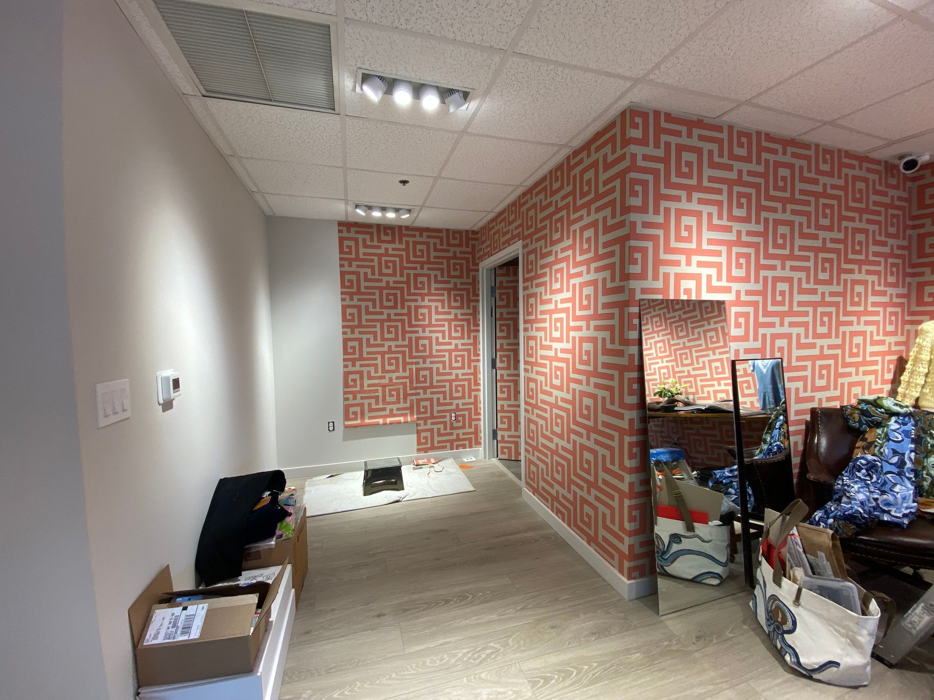 A room with a maze pattern on the walls and a mirror.