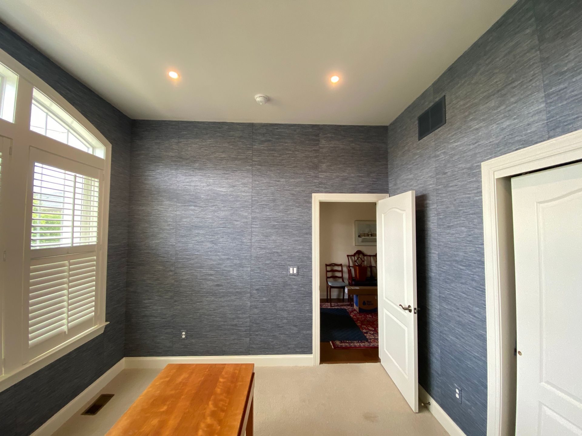 A room with blue walls and a wooden table.