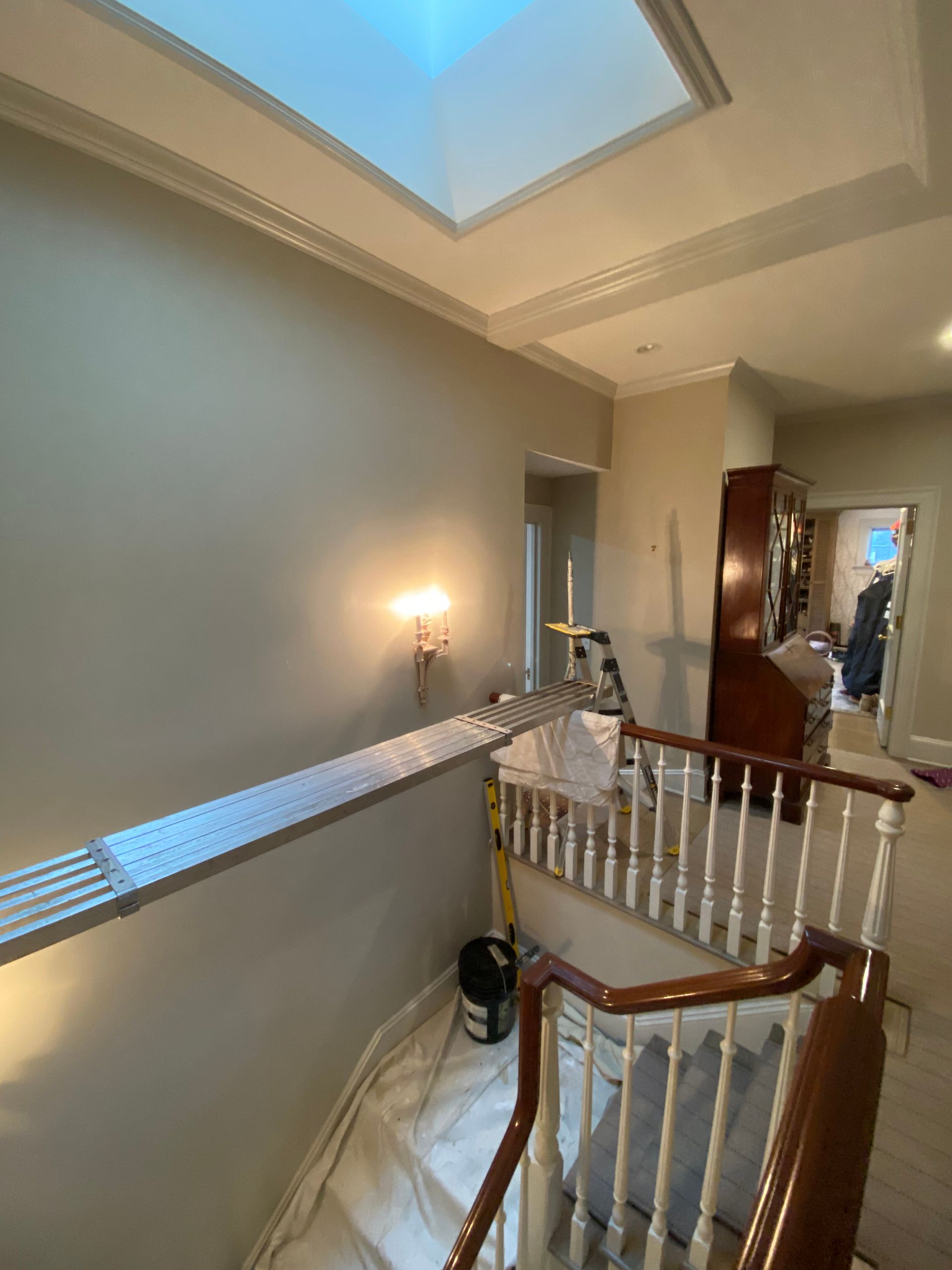 A staircase in a house with a skylight above it.