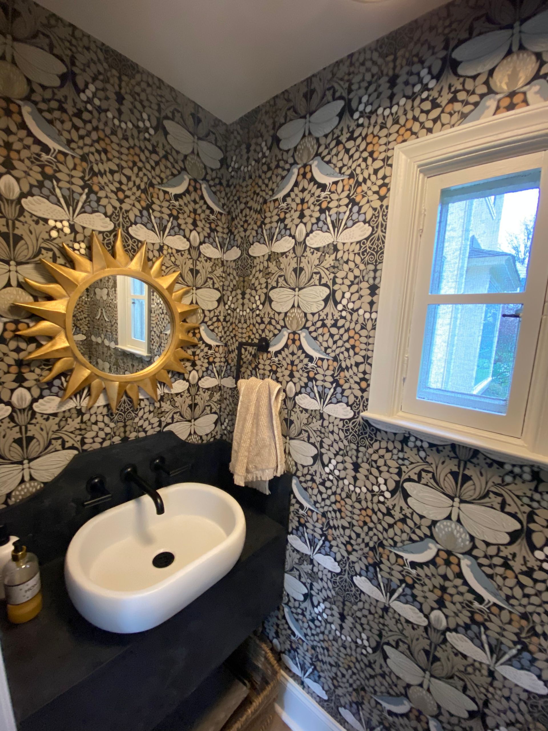 A bathroom with a sink a mirror and a window