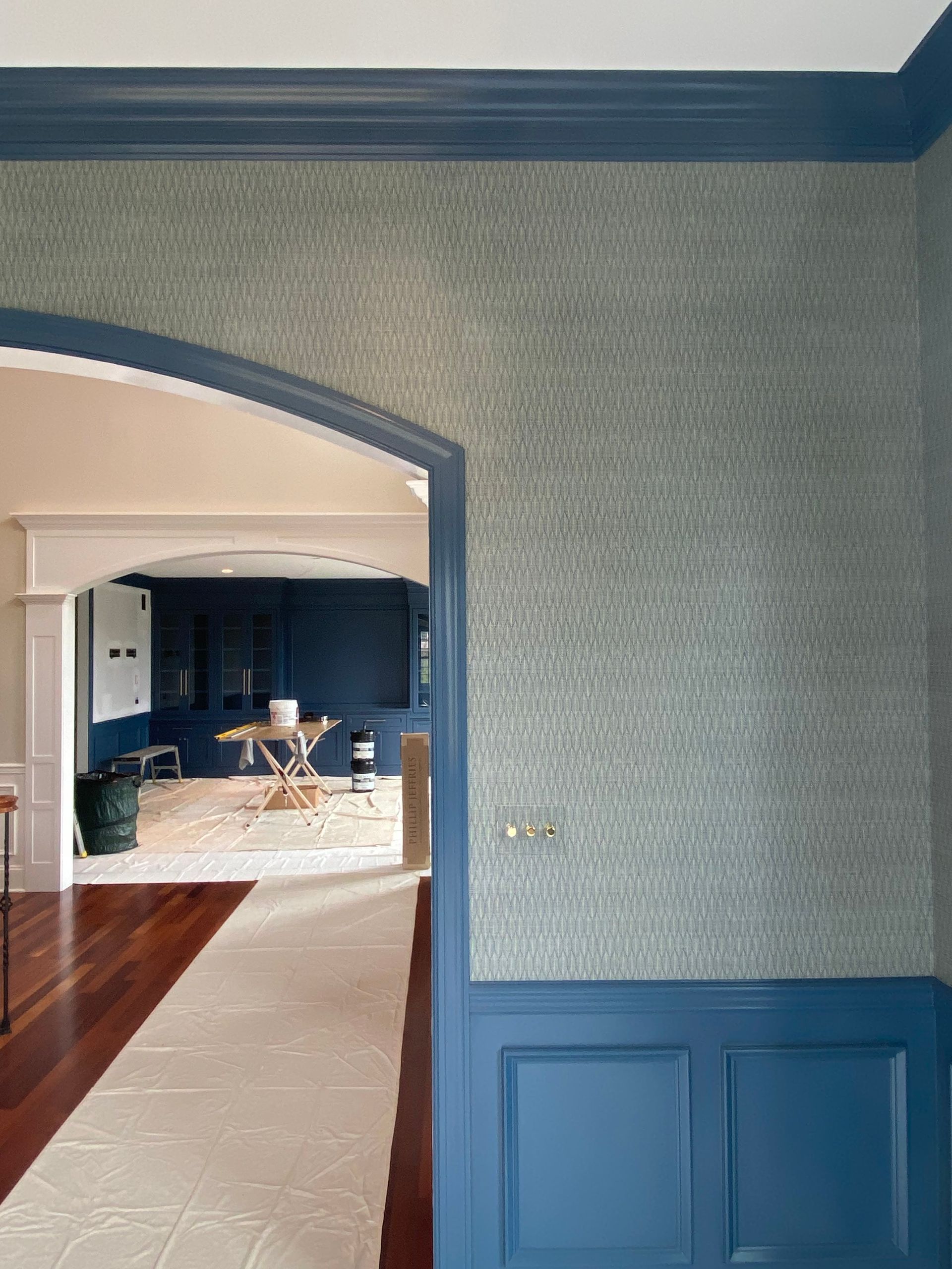 A doorway leading to a living room with a table and chairs.