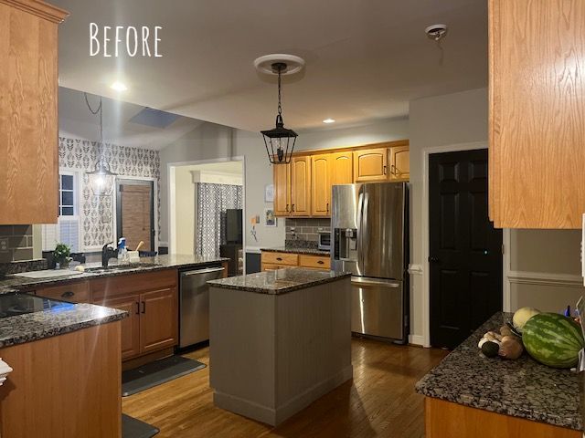 Kitchen Remodeling: A kitchen with stainless steel appliances and wooden cabinets before being remodeled.