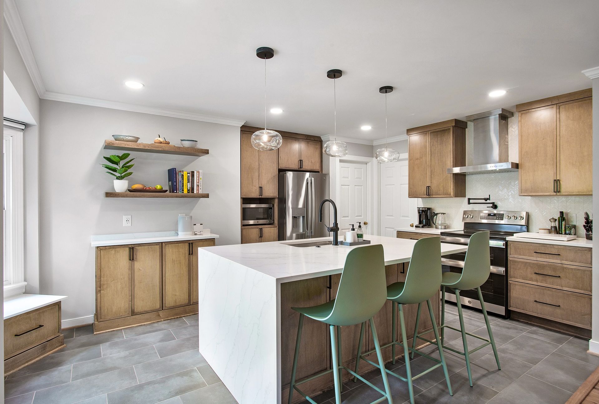 Kitchen Remodeler: A kitchen with wooden cabinets , stainless steel appliances , and a large island.