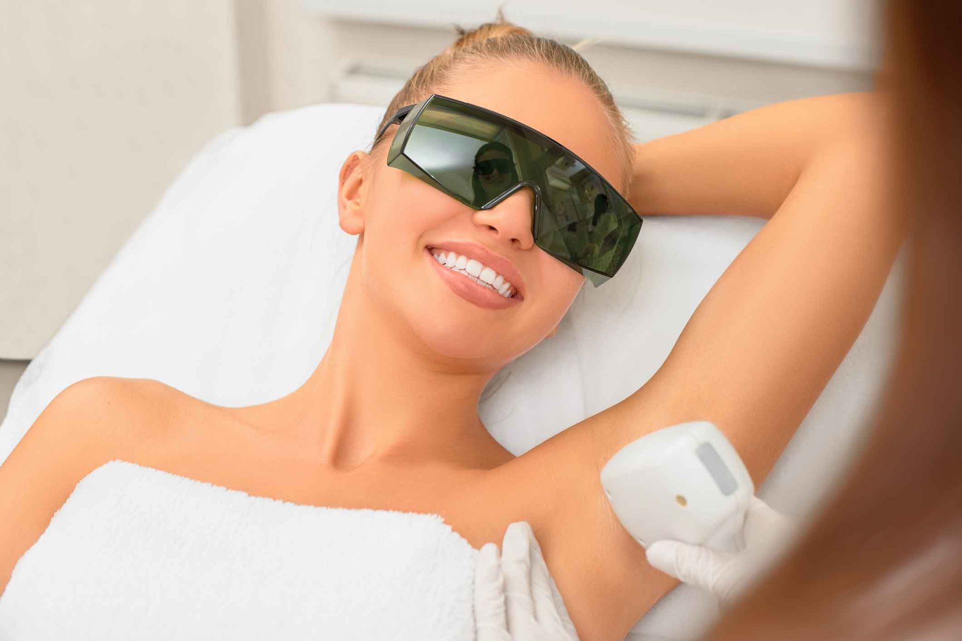 A woman is getting a laser treatment on her face – Rapid Creek, NT - Urban Wax & Beauty