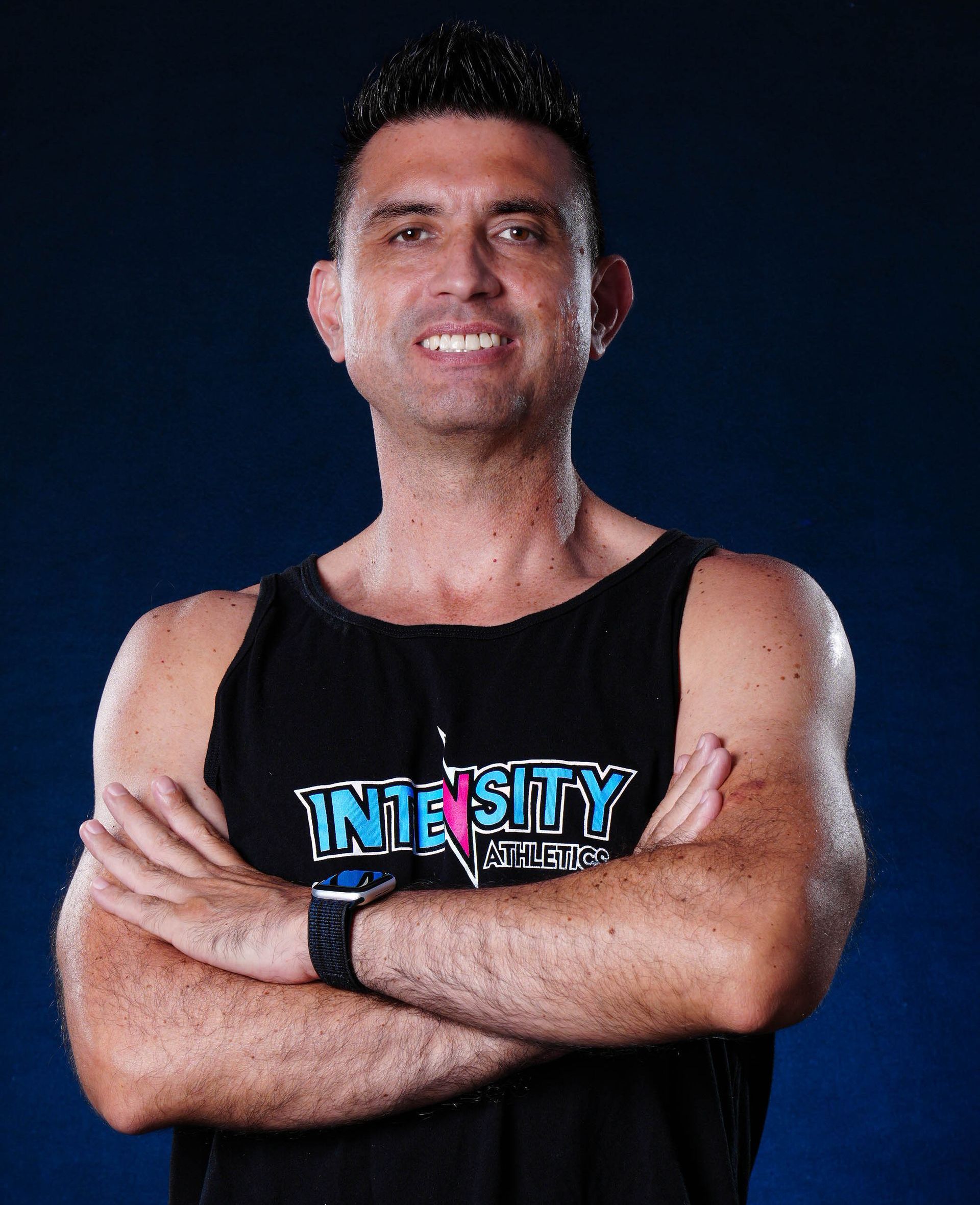 A man wearing a black tank top with the word intensity on it