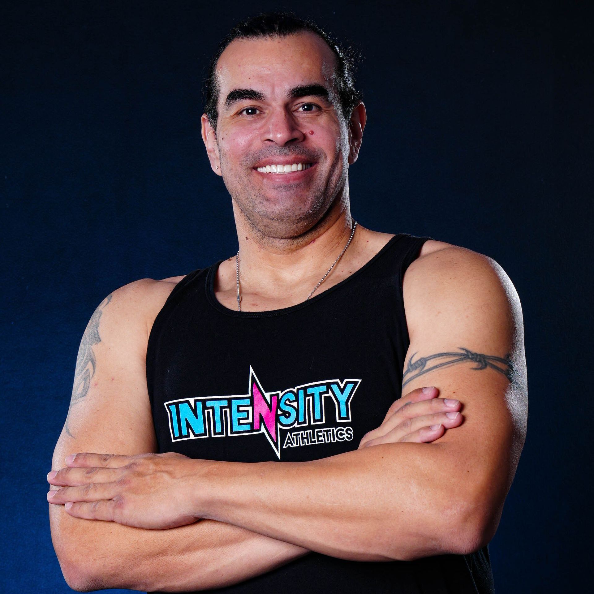 A man wearing a black tank top with the word intensity on it