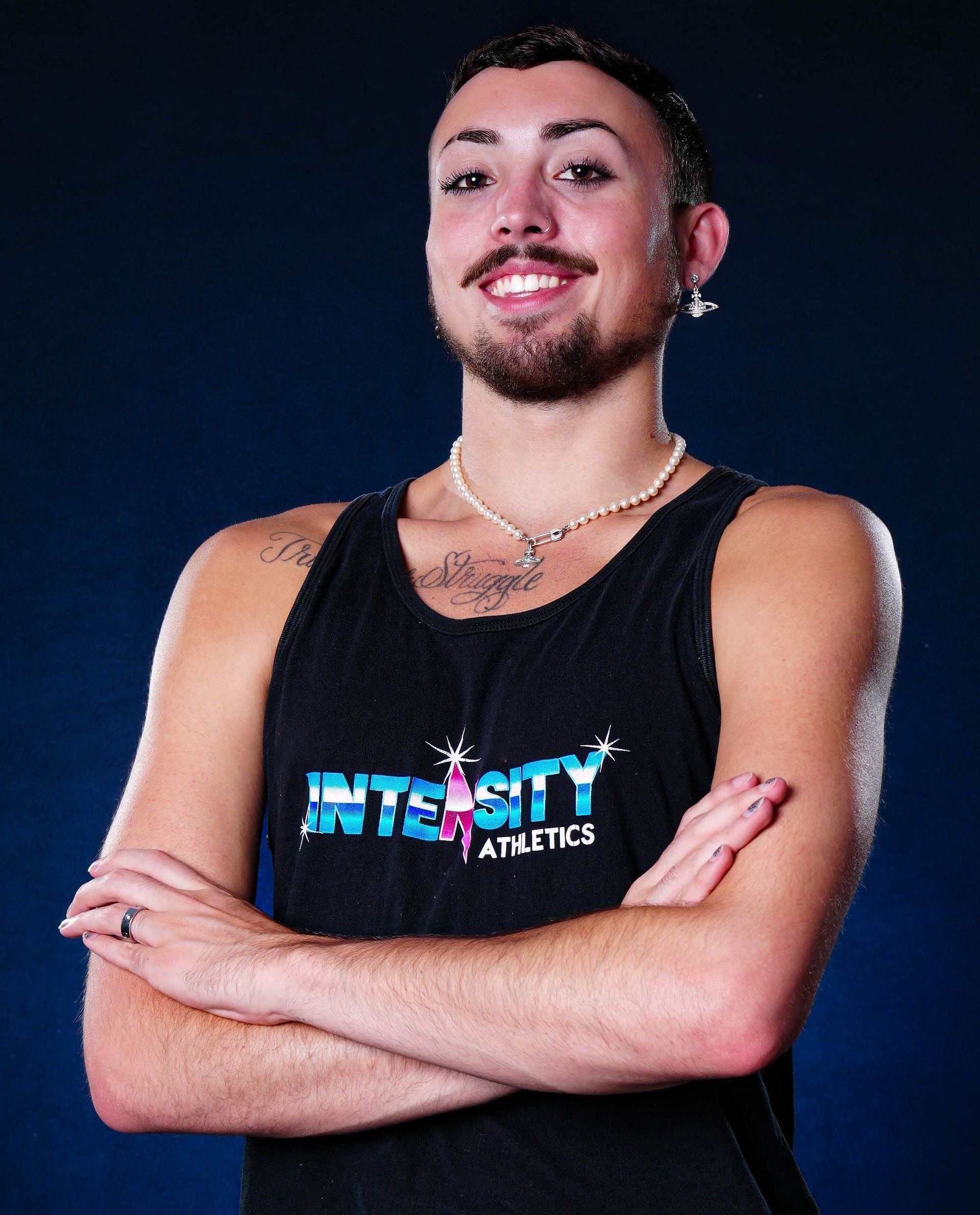 A man wearing a black tank top that says integrity athletics