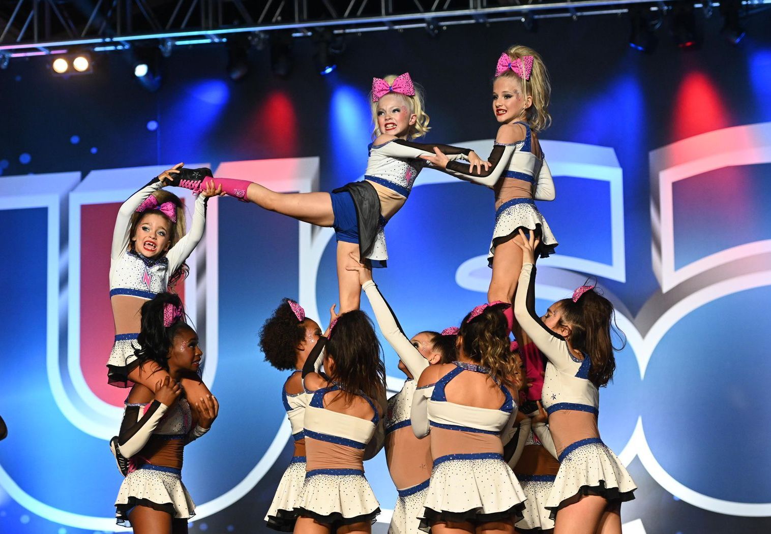 A group of cheerleaders are performing on a stage