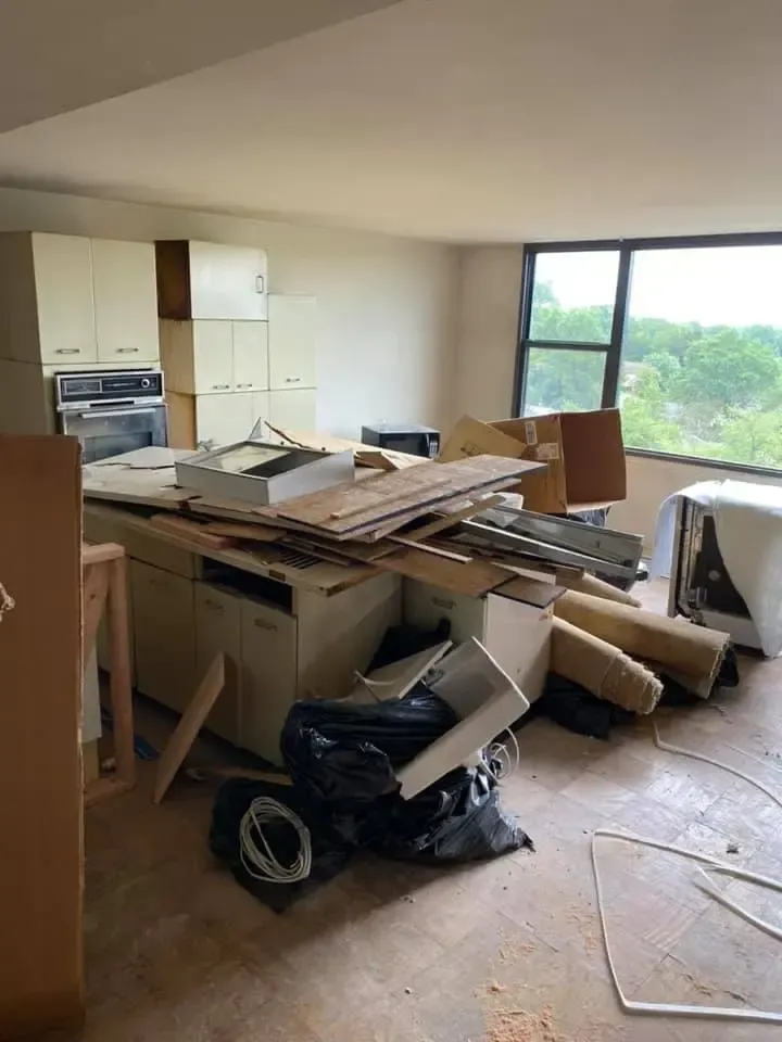 a living room filled with lots of junk and boxes .