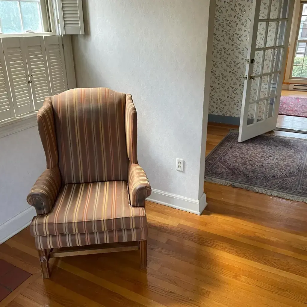 a chair is sitting in a room next to a door