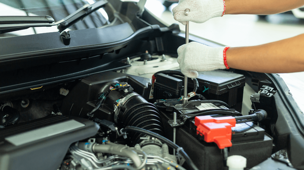 a mechanic doing an auto repair outside
