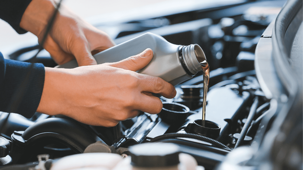a mechanic doing an oil change