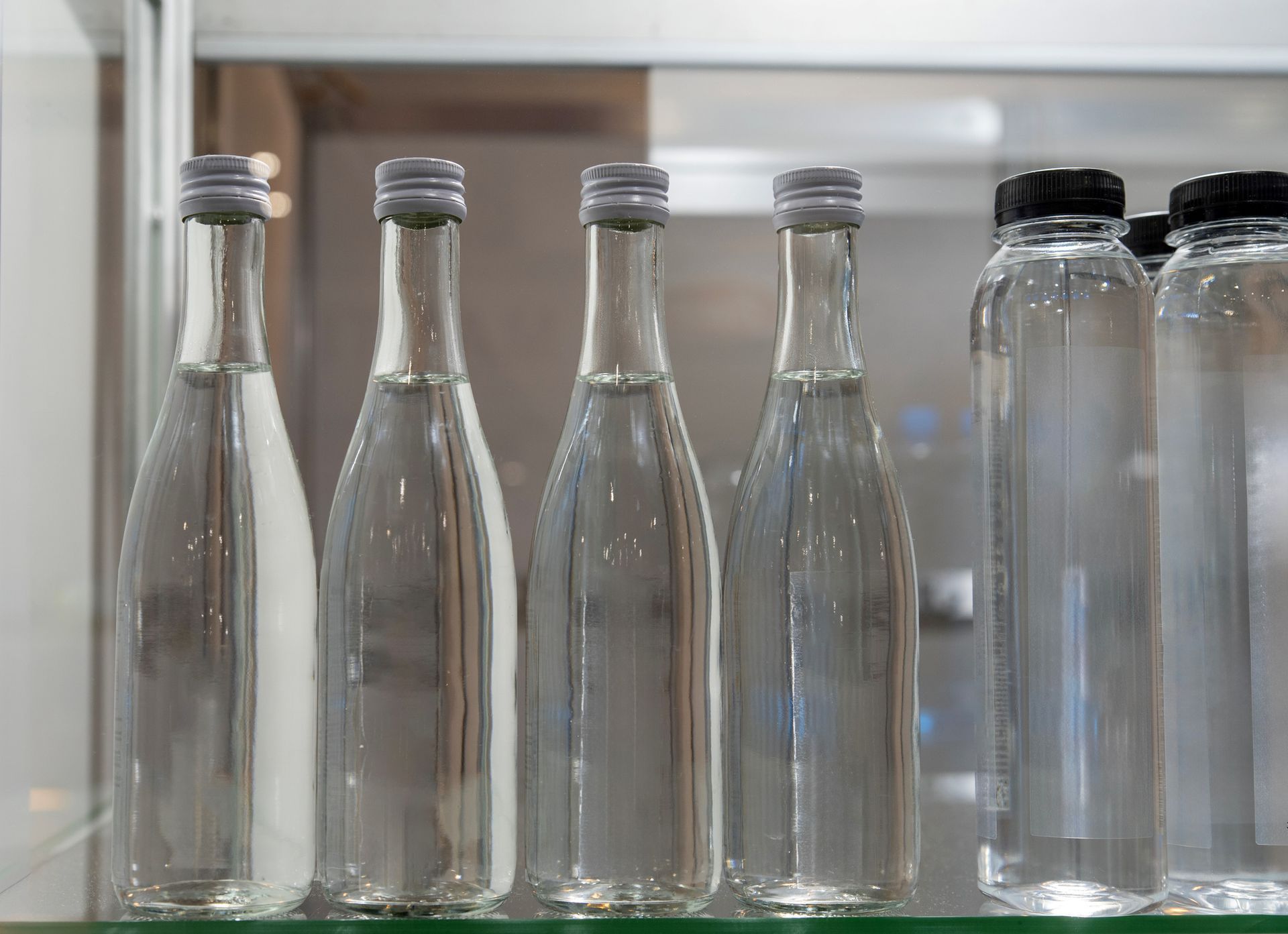 Glass water bottles with silver lids. Glass water bottles with silver lids.