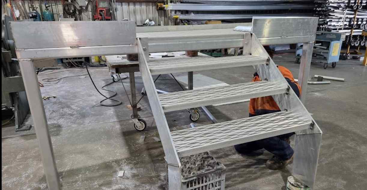 Man Checking Metal Alignment - We Create Stair Stringers in Lismore, NSW