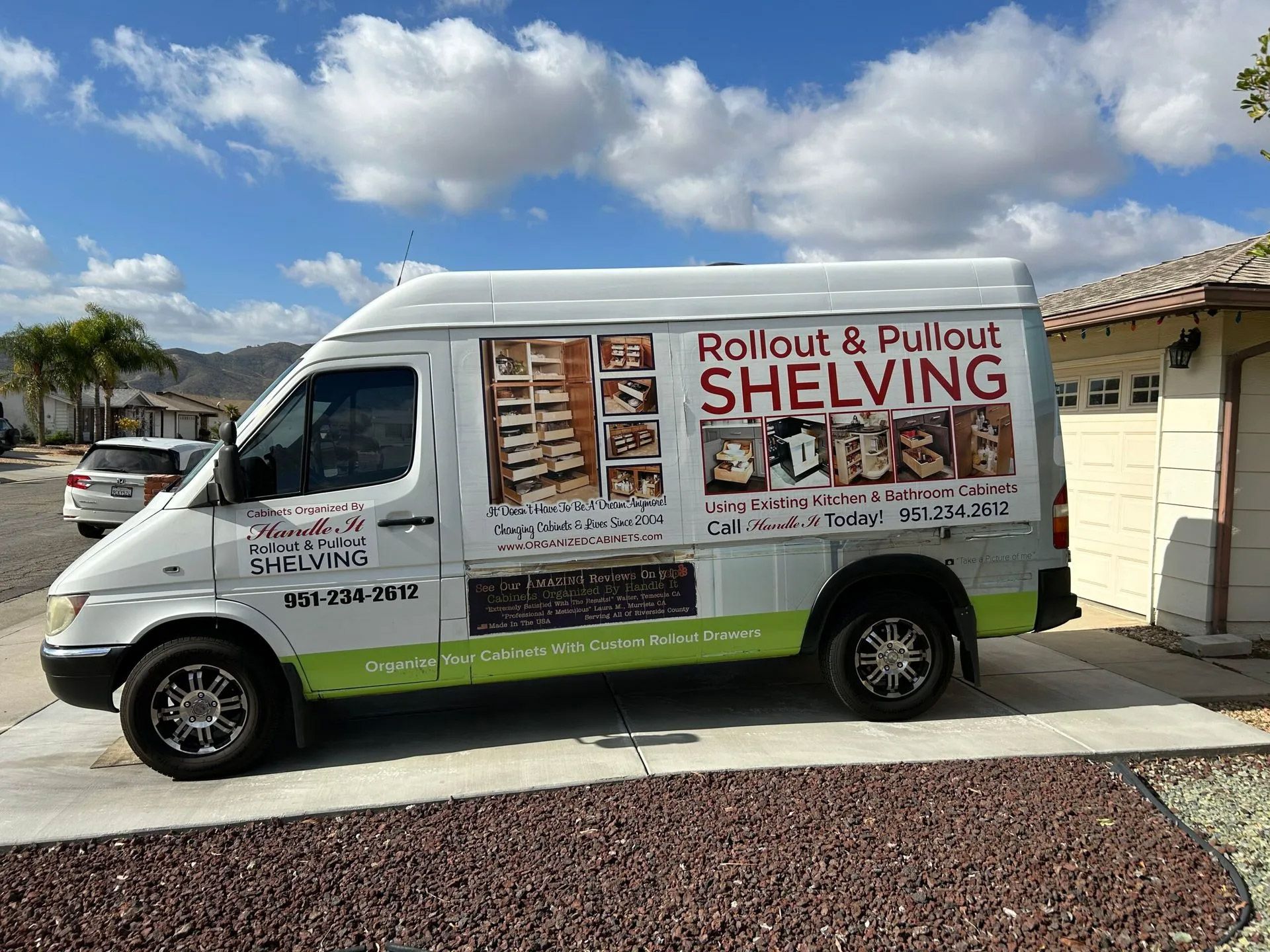 A white van is parked on the side of the road.