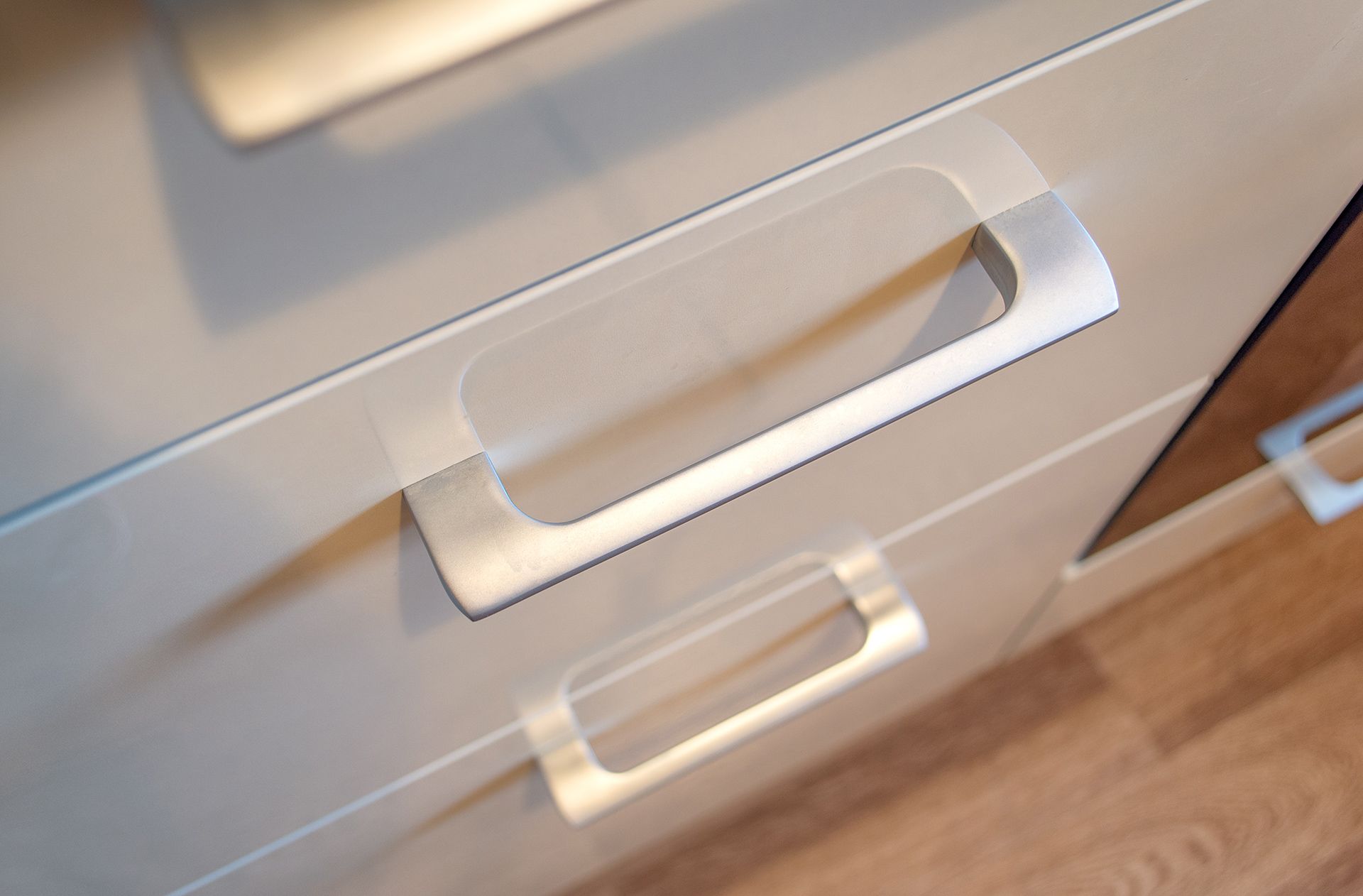 A close up of a drawer with a silver handle