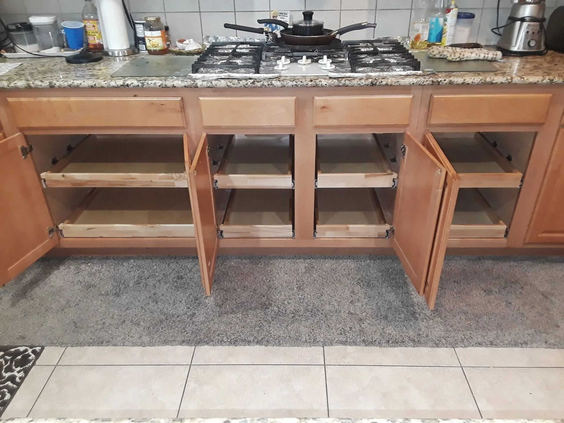 A kitchen with wooden cabinets and a stove top oven