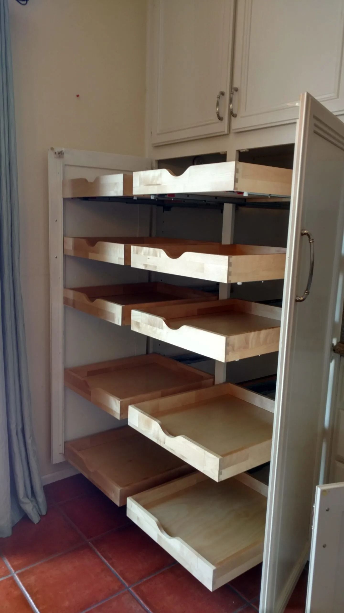 A shelf with lots of drawers in a kitchen