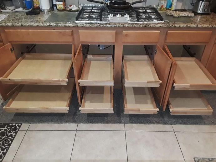 A large kitchen with white cabinets and a large island in the middle.
