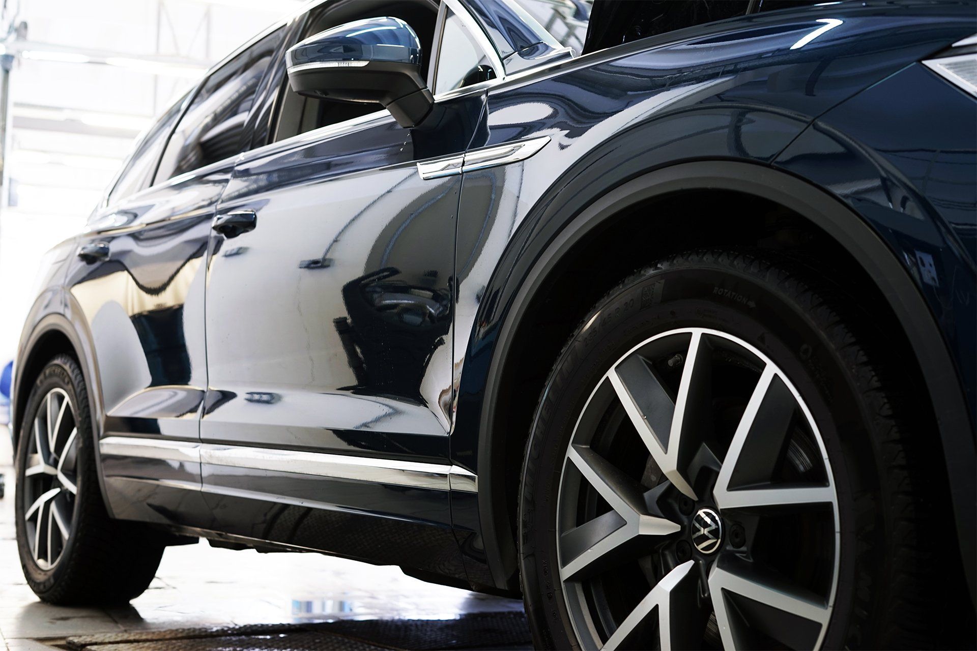 A Man Applying Ceramic Coating on a Red Car