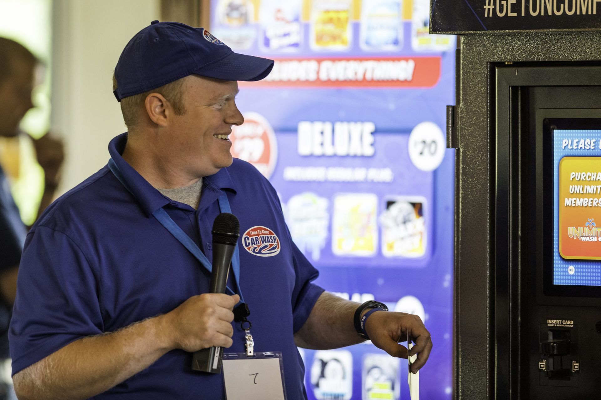 A man standing in front of a machine that says deluxe