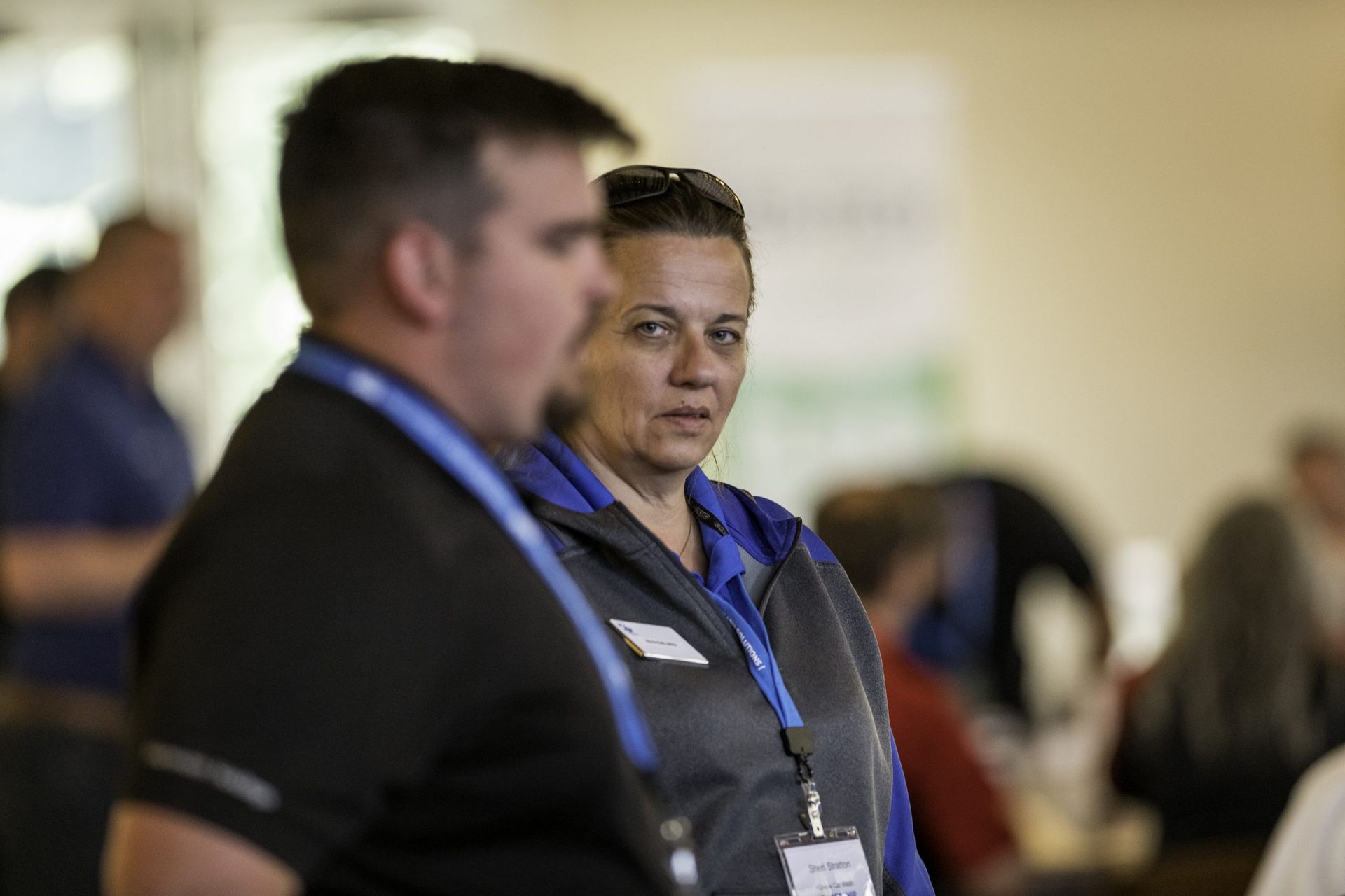 A man and a woman are standing next to each other in a room.