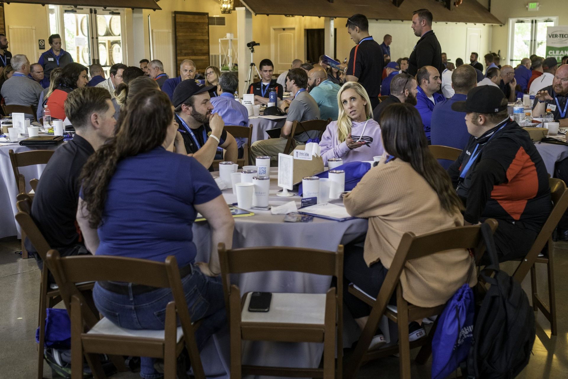 A group of people are sitting at tables in a room.