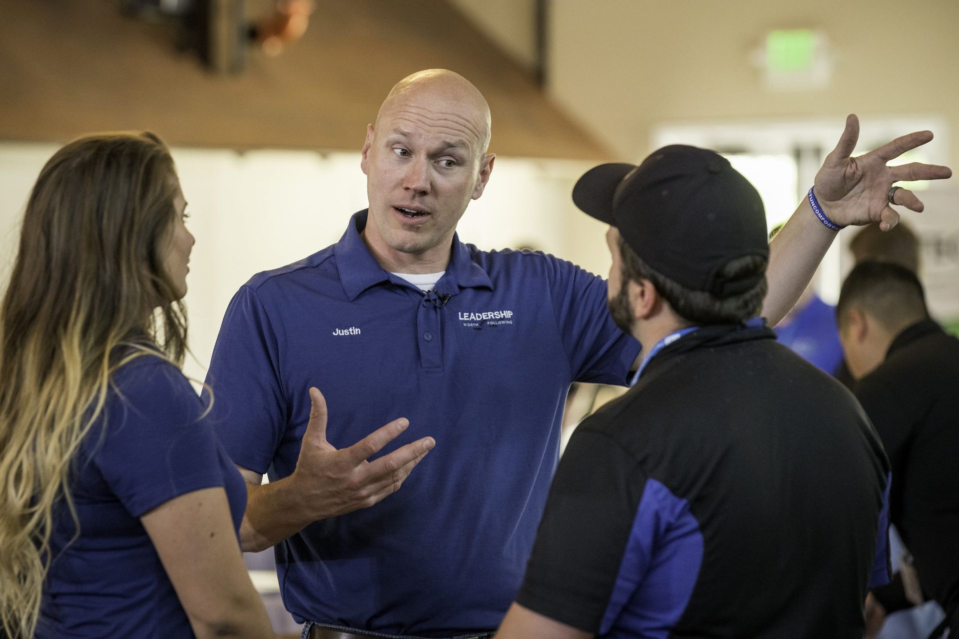 A group of people are talking to each other in a room.