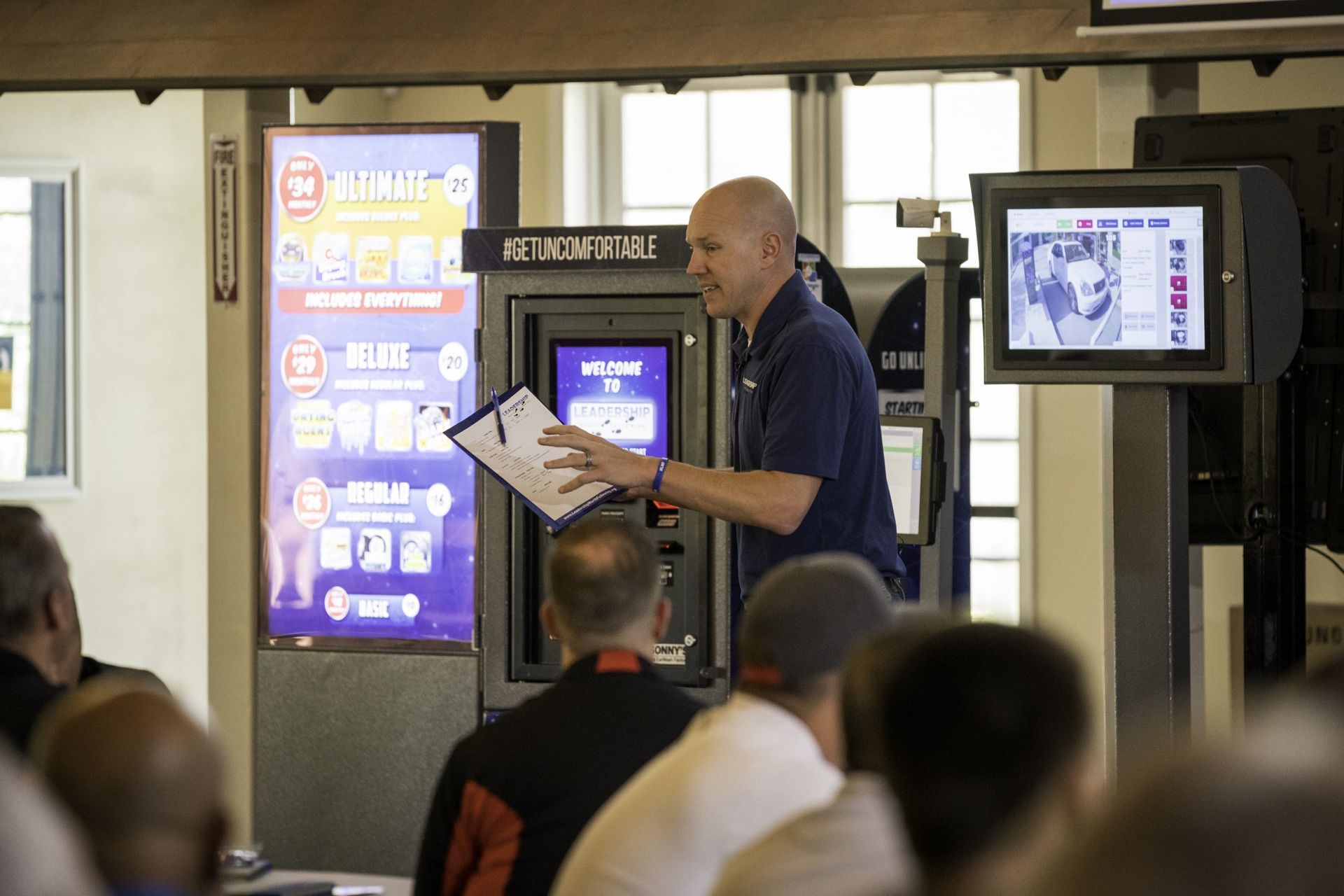 A man stands in front of a bank 6 machine