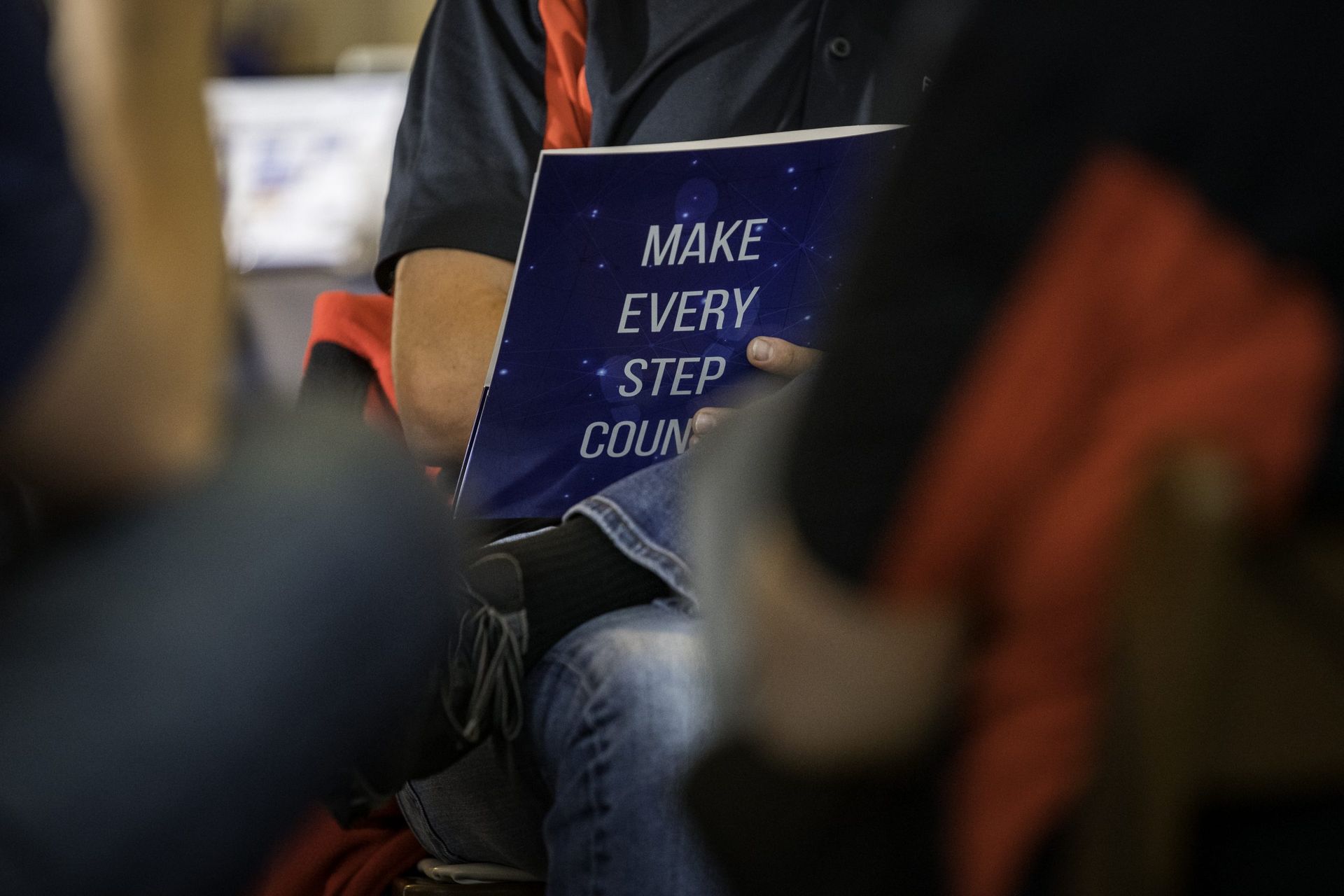 A person is holding a book that says `` make every step count ''.