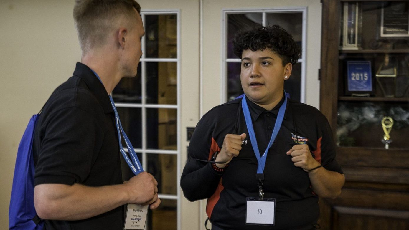 A man and a woman are talking to each other in a room.
