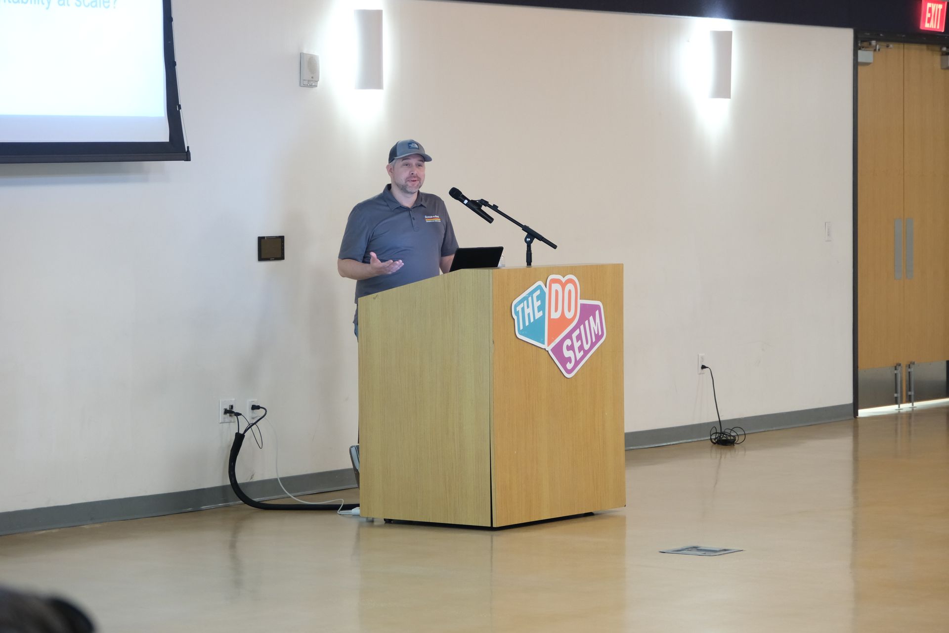 A man is standing at a podium giving a presentation.